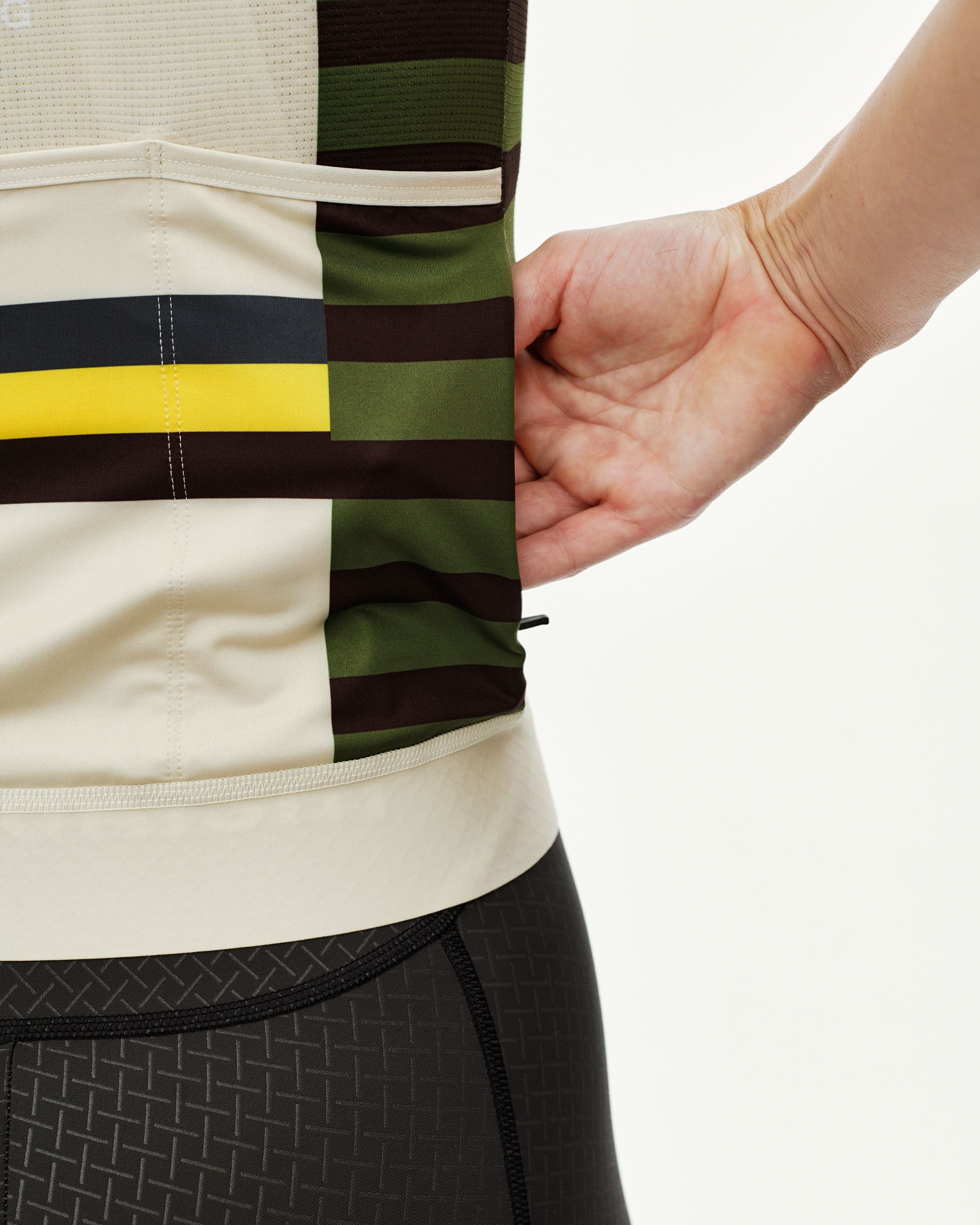 International Sand Mechanism women's cycling jersey, side detail on model with multicolor block stripe print