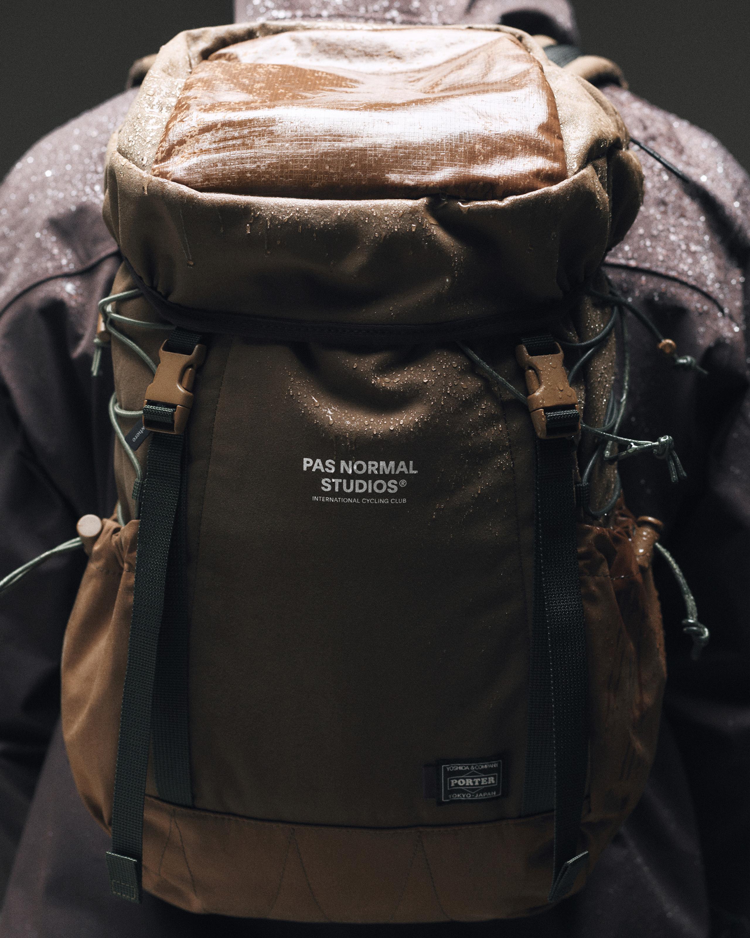 Light Brown Porter-Yoshida backpack on model, front view with ripstop top panel and clip buckle straps