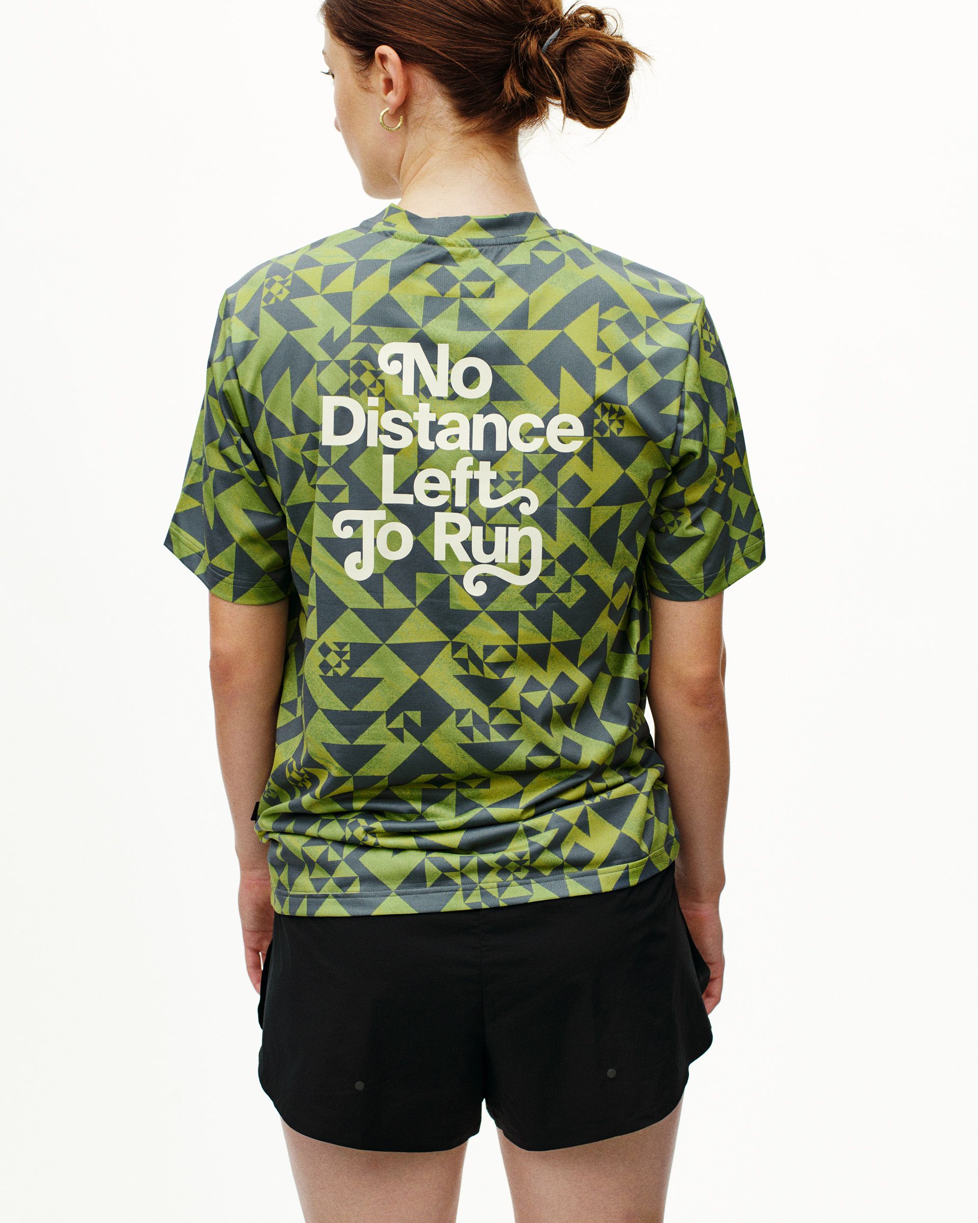 Green Balance t-shirt on model, rear view with geometric print and white back text