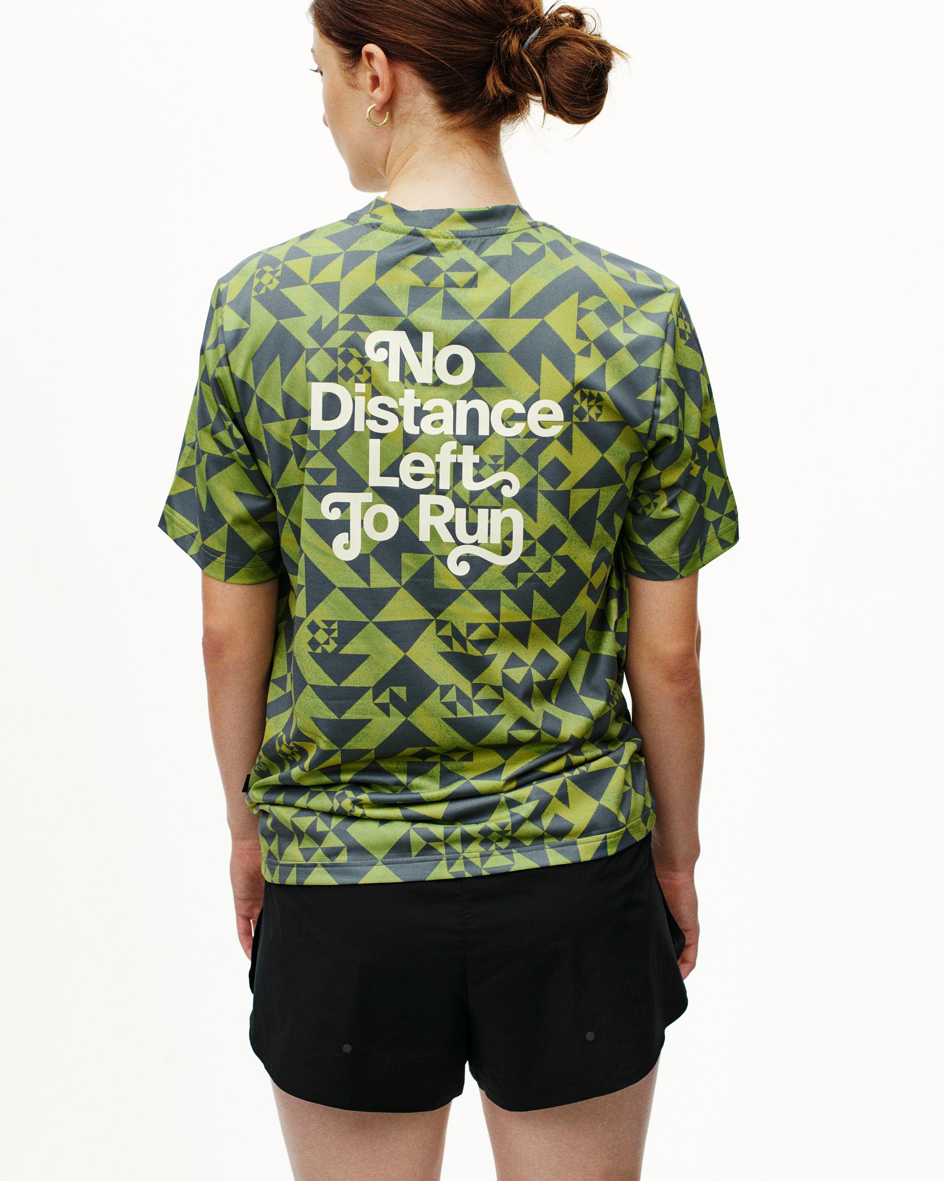 Green Balance t-shirt on model, rear view with geometric print and white back text