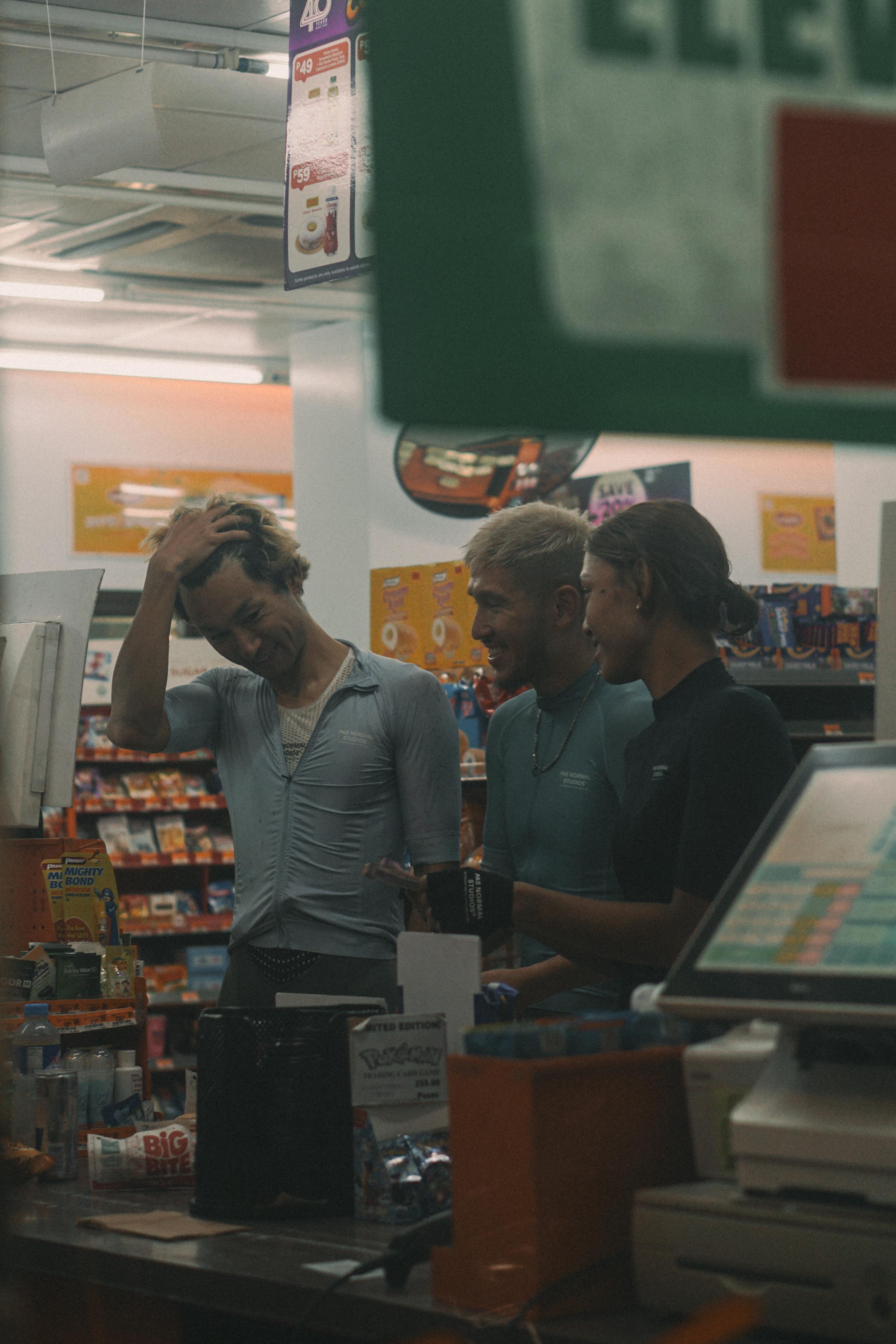 Models wearing cycling apparel in convenience store setting