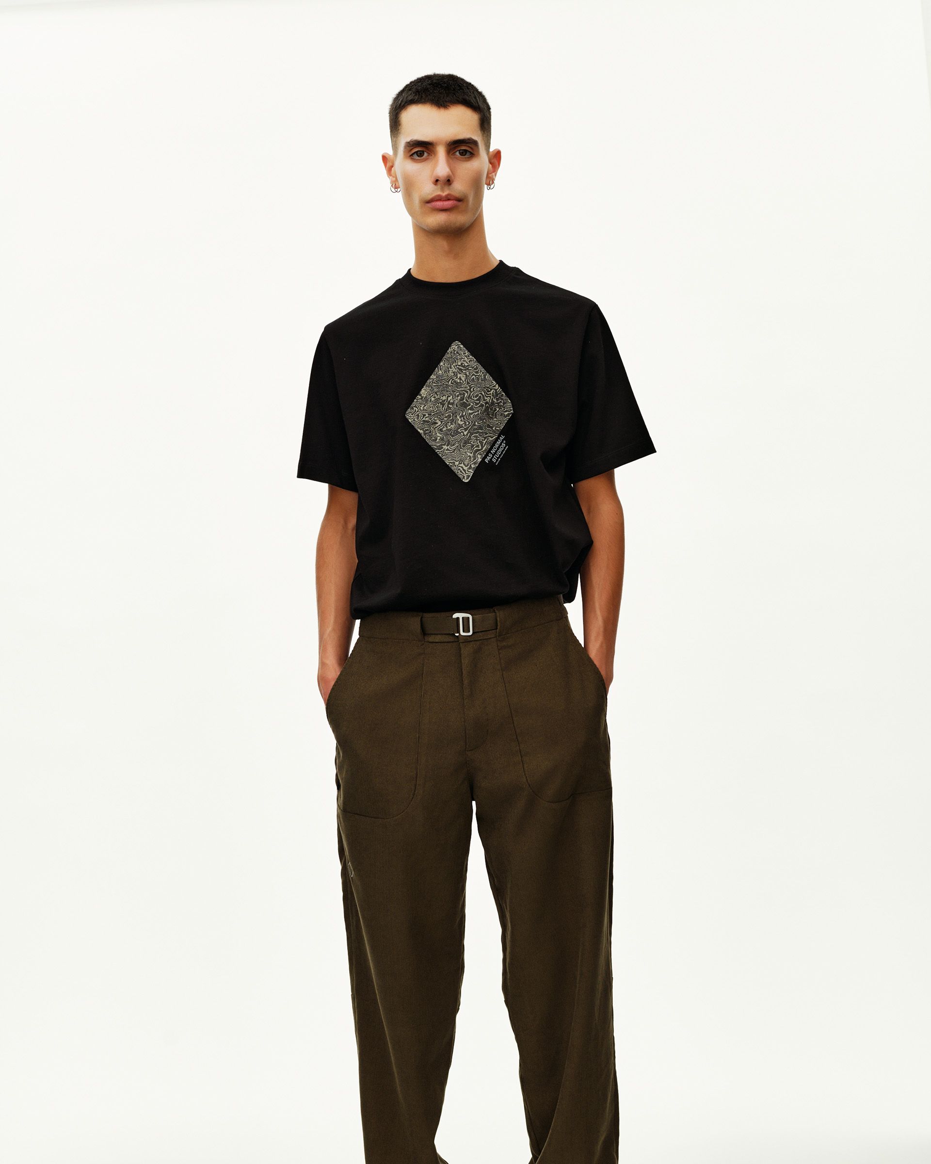 Dark Olive Off-Race Corduroy pants on model, front view with belted waist and wide leg