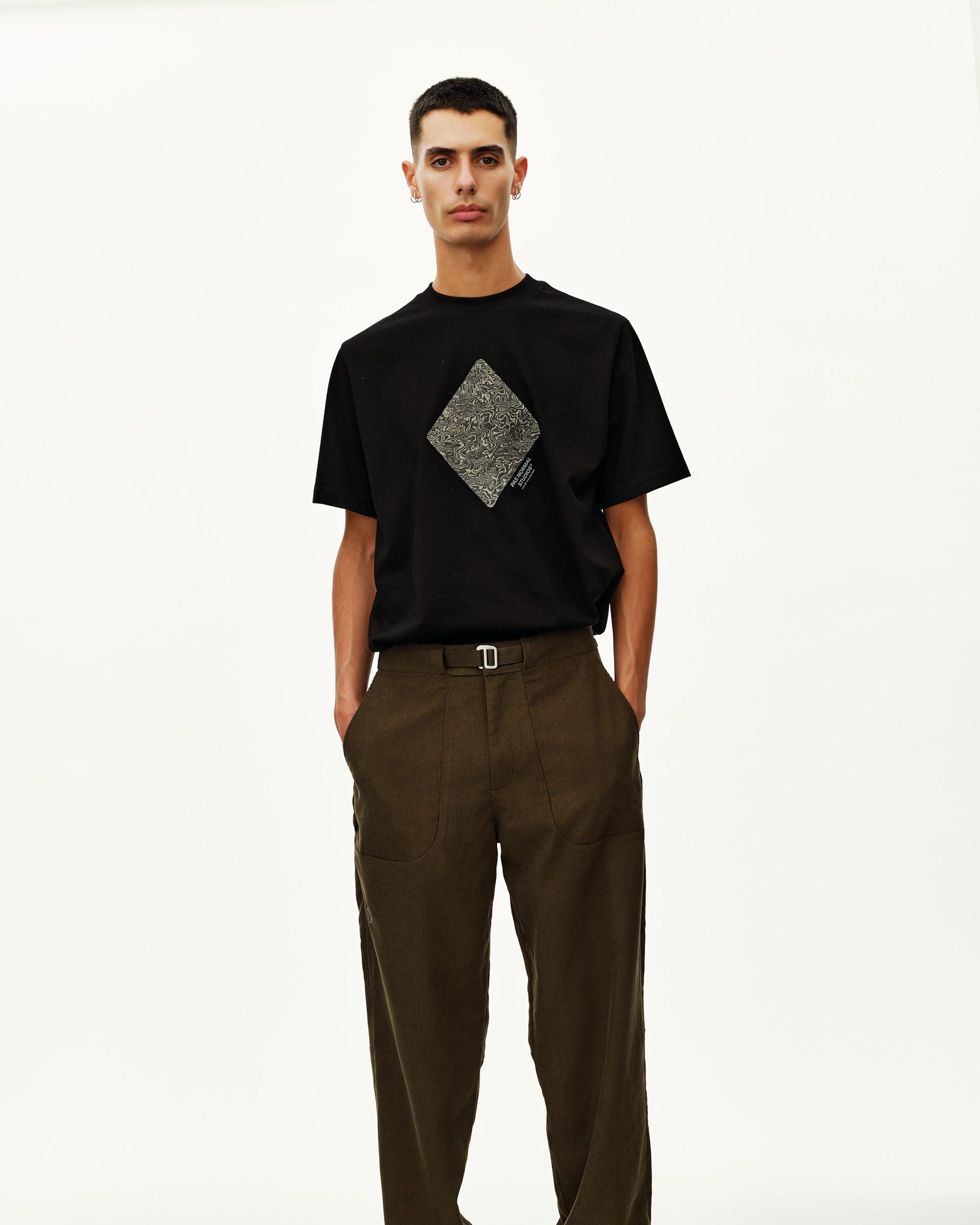 Dark Olive Off-Race Corduroy pants on model, front view with belted waist and wide leg
