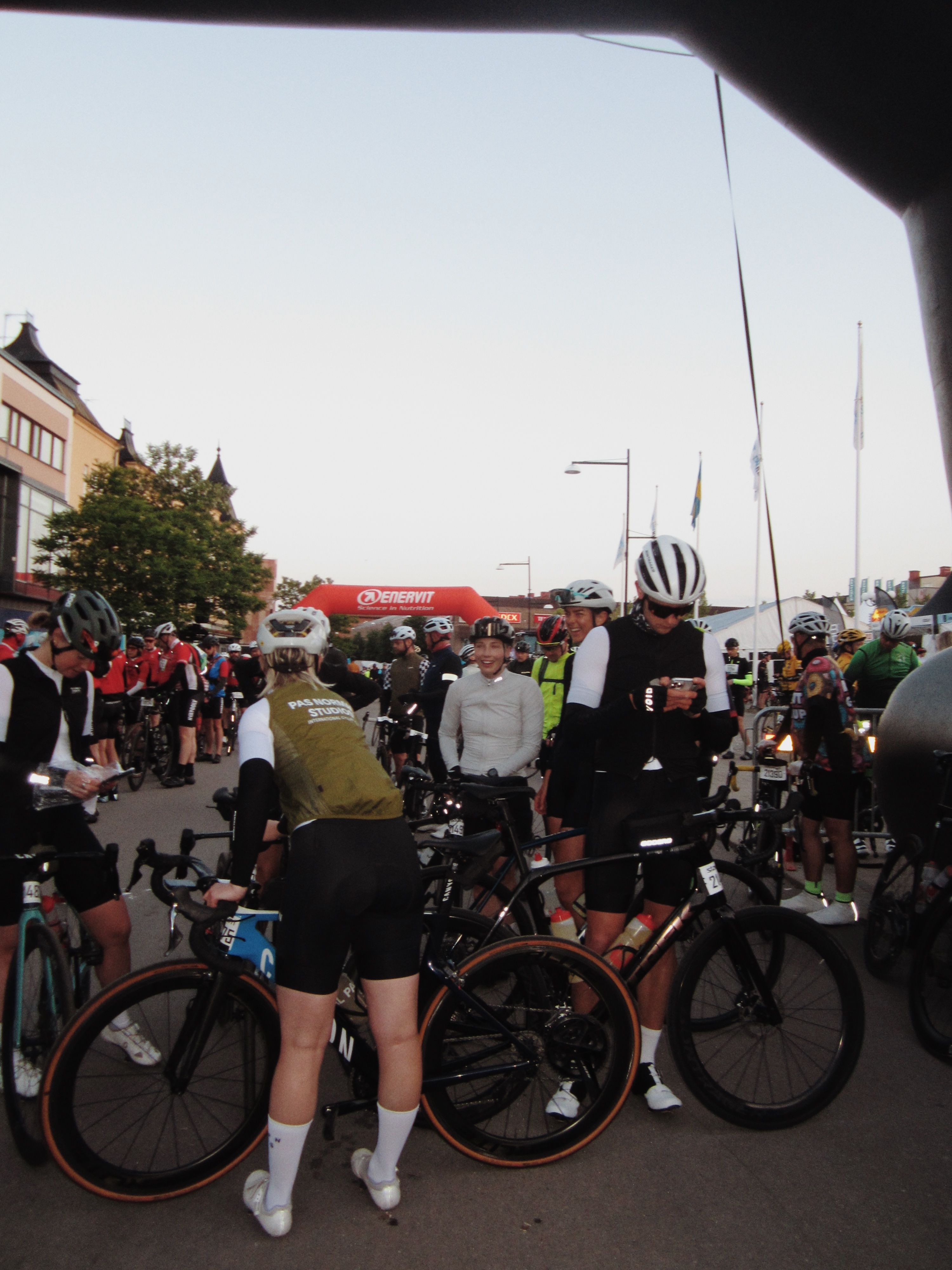 Cyclists gathered at Vätternrundan event with olive jersey rider in foreground