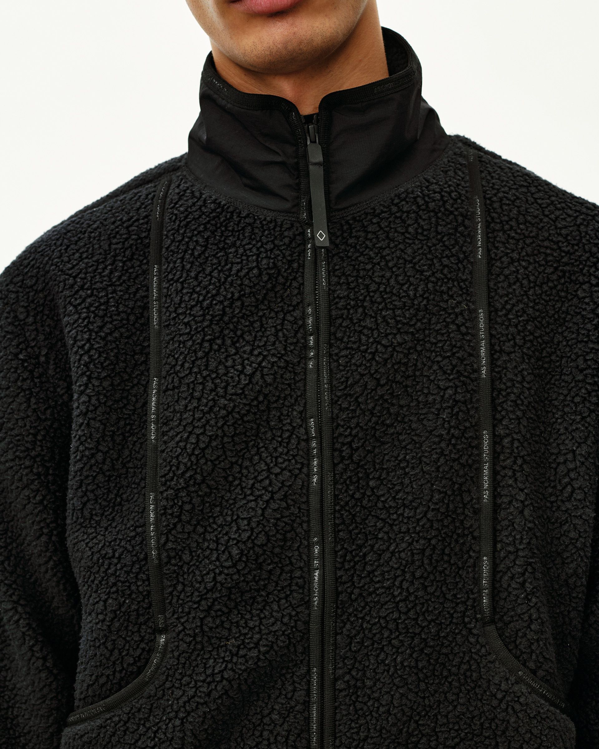Black Off-Race Pile Fleece jacket, front detail on model with full zip and logo tape trim