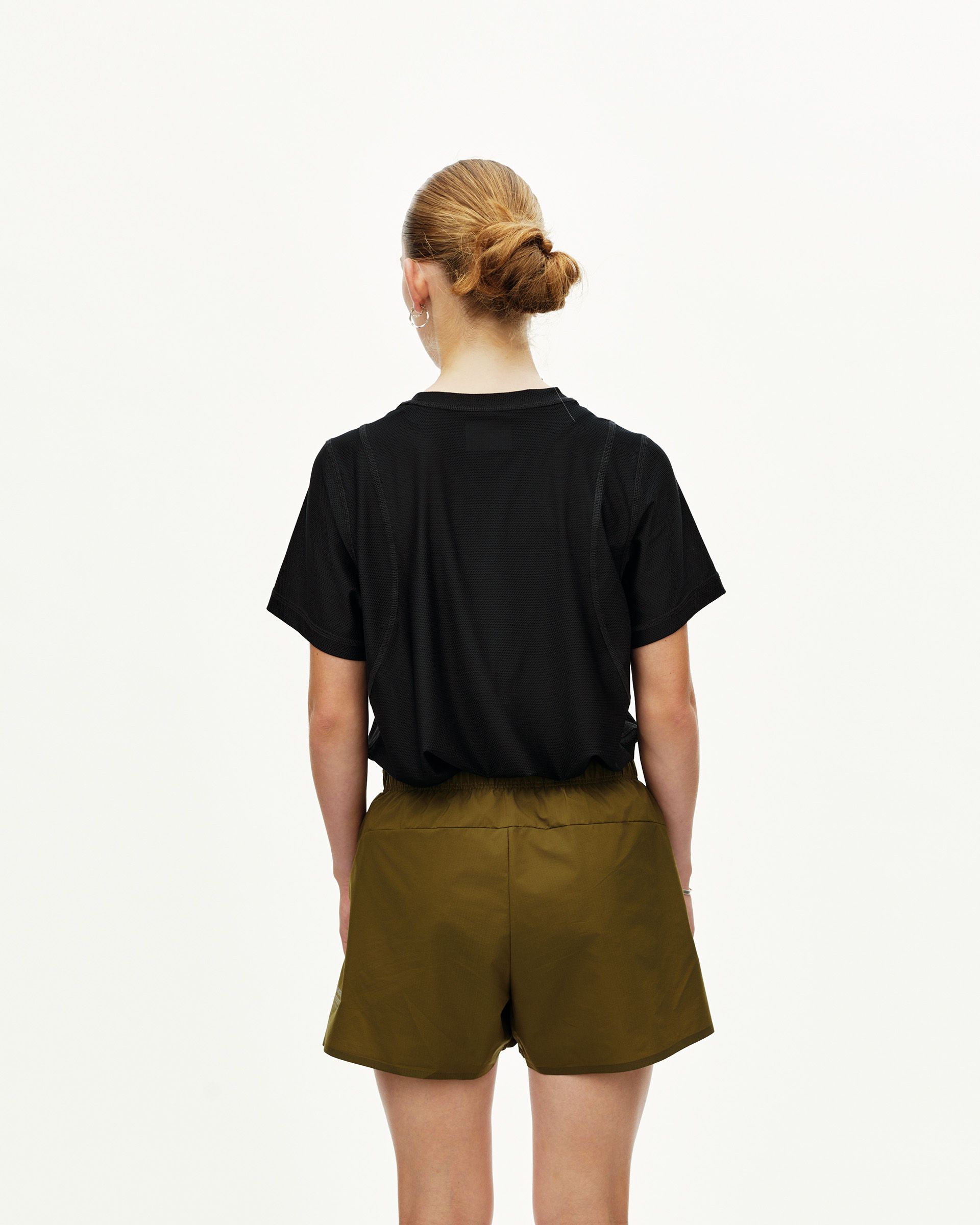 Moss Brown Balance women's shorts on model, rear view with elastic waistband