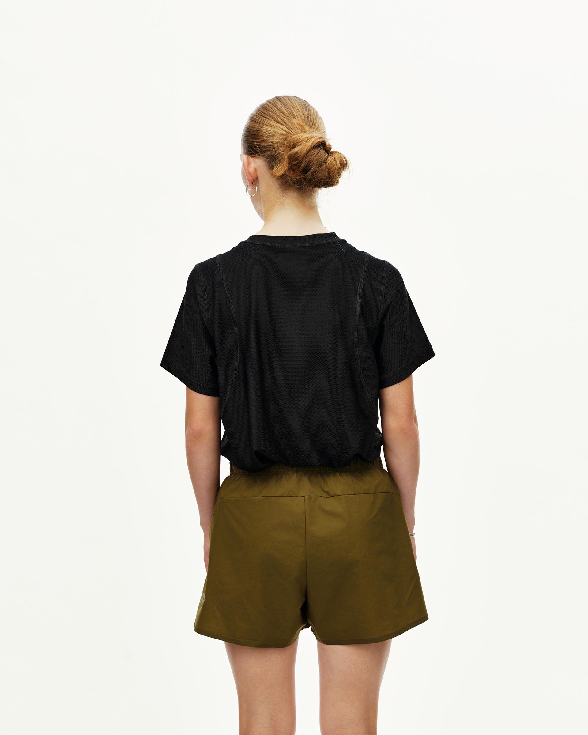 Moss Brown Balance women's shorts on model, rear view with elastic waistband
