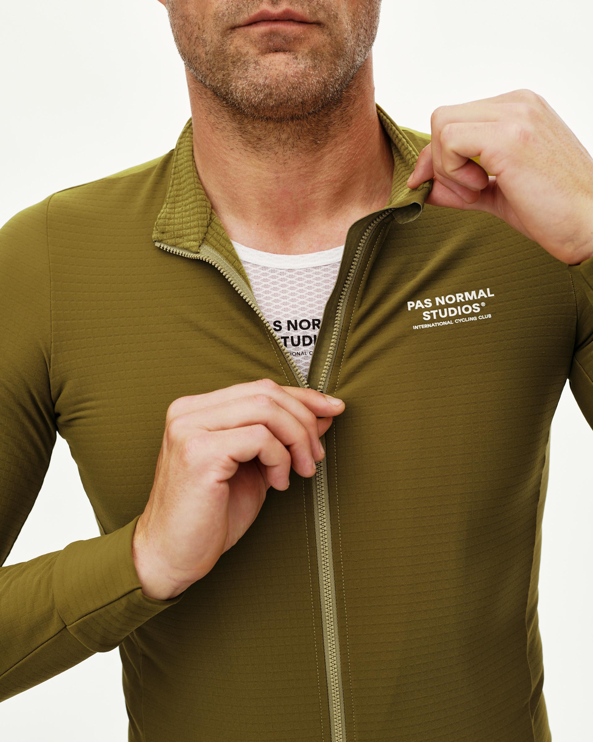 Khaki Green Essential long sleeve cycling jersey, front detail on model with full zip open and white chest print