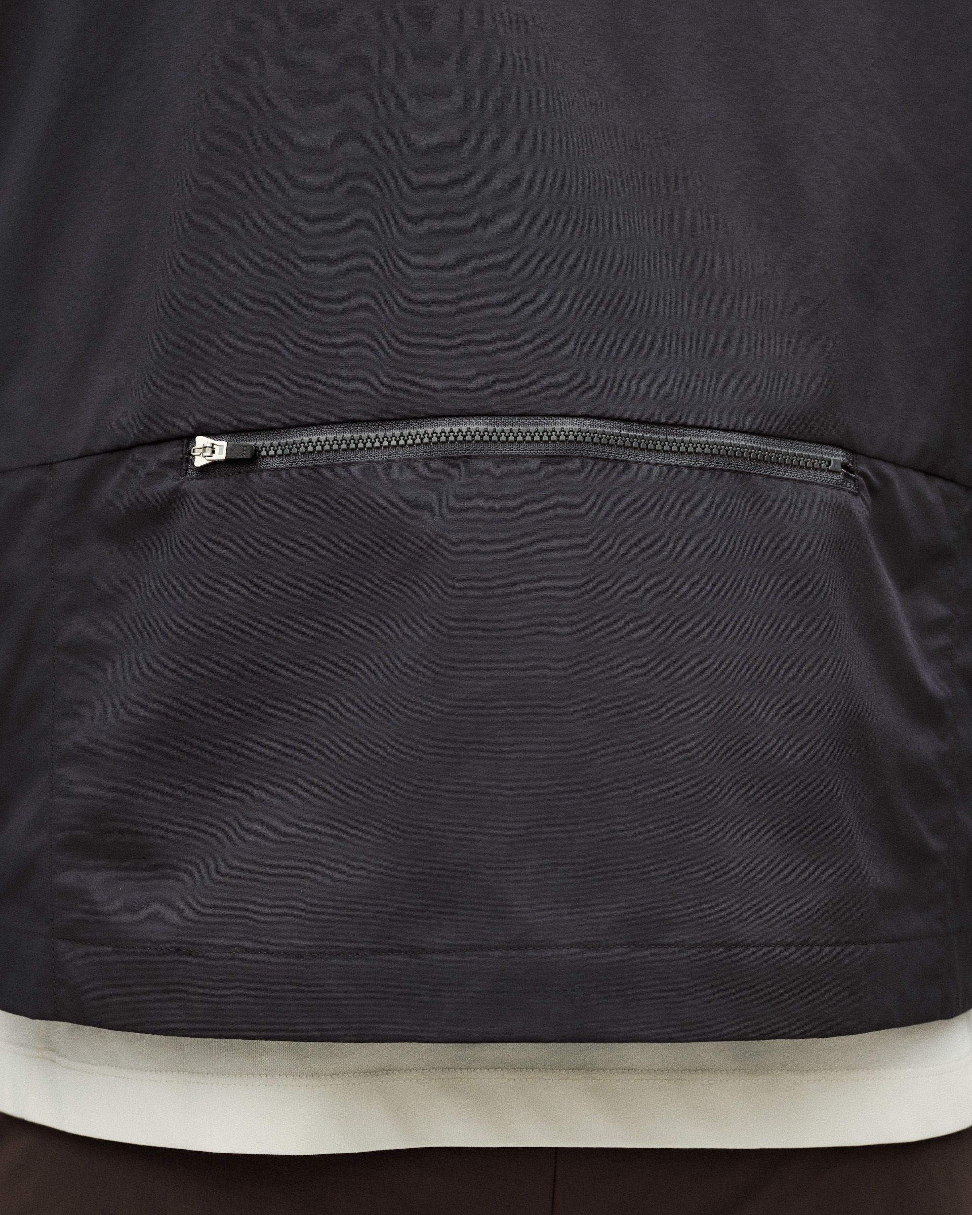 Grey Off-Race Utility vest, rear flat lay showing horizontal zip pocket