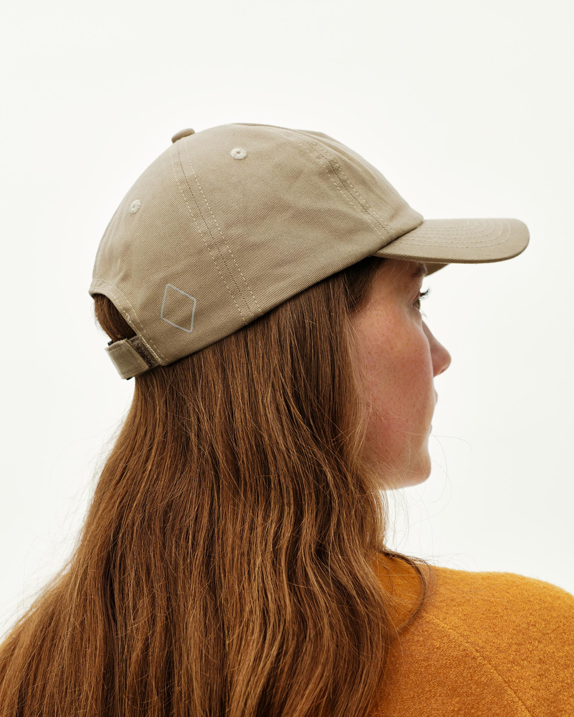 Dusty Earth khaki Off-Race Cotton cap on model, three-quarter rear view with tone-on-tone logo patch