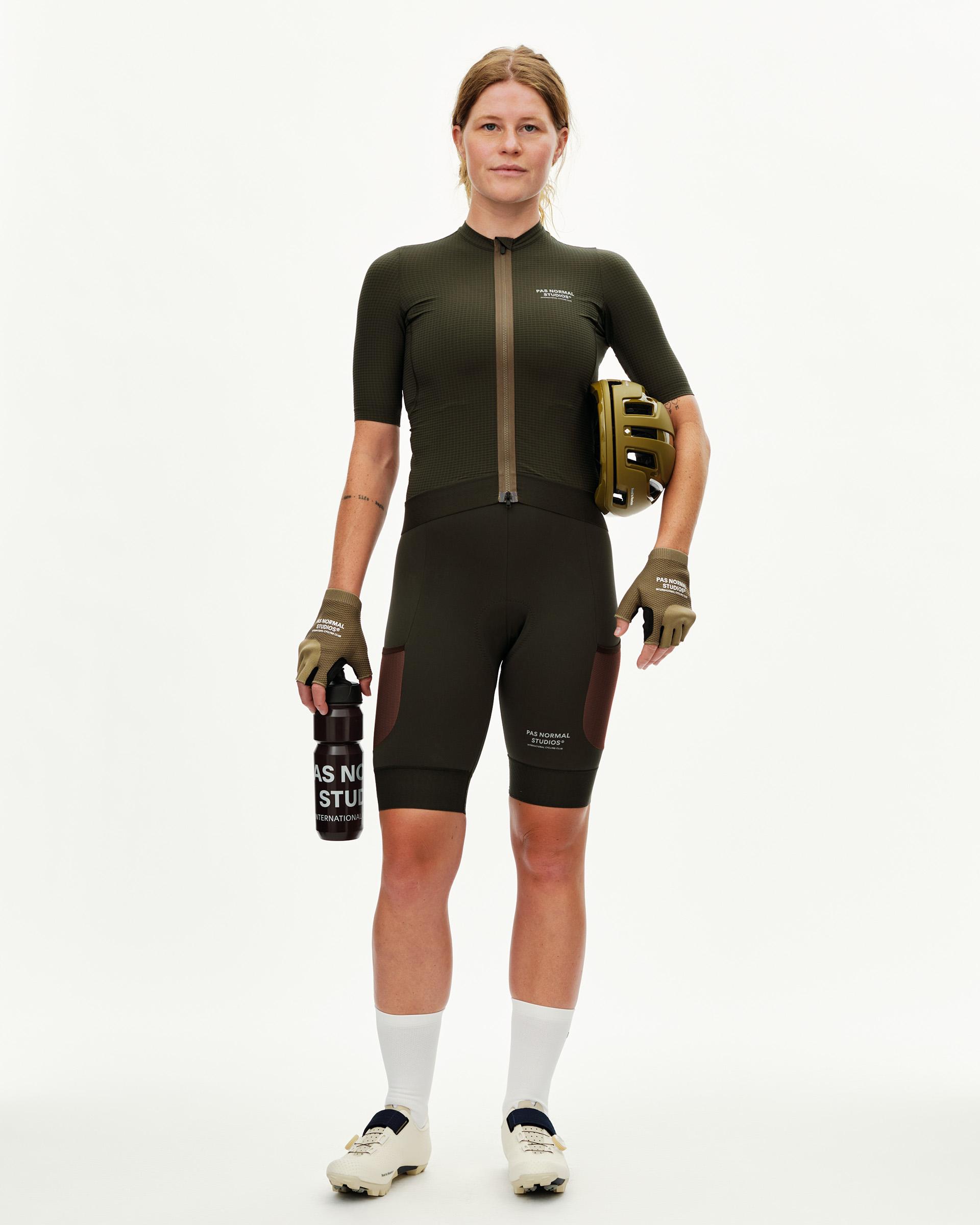Dark Olive Escapism women's cycling jersey on model, front view with textured fabric and contrast zip