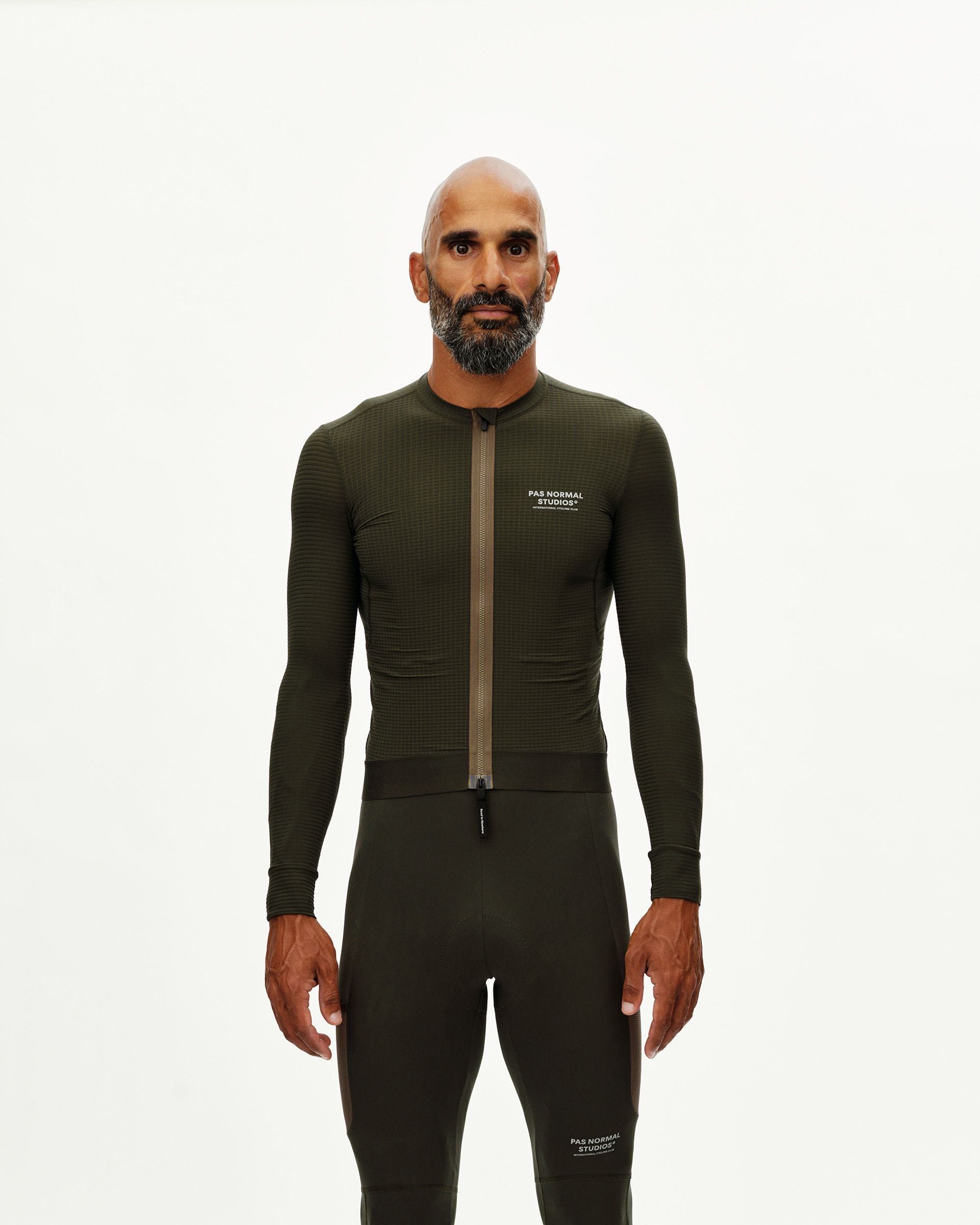 Dark Olive Escapism long sleeve cycling jersey on model, front view with full-length zip and textured fabric