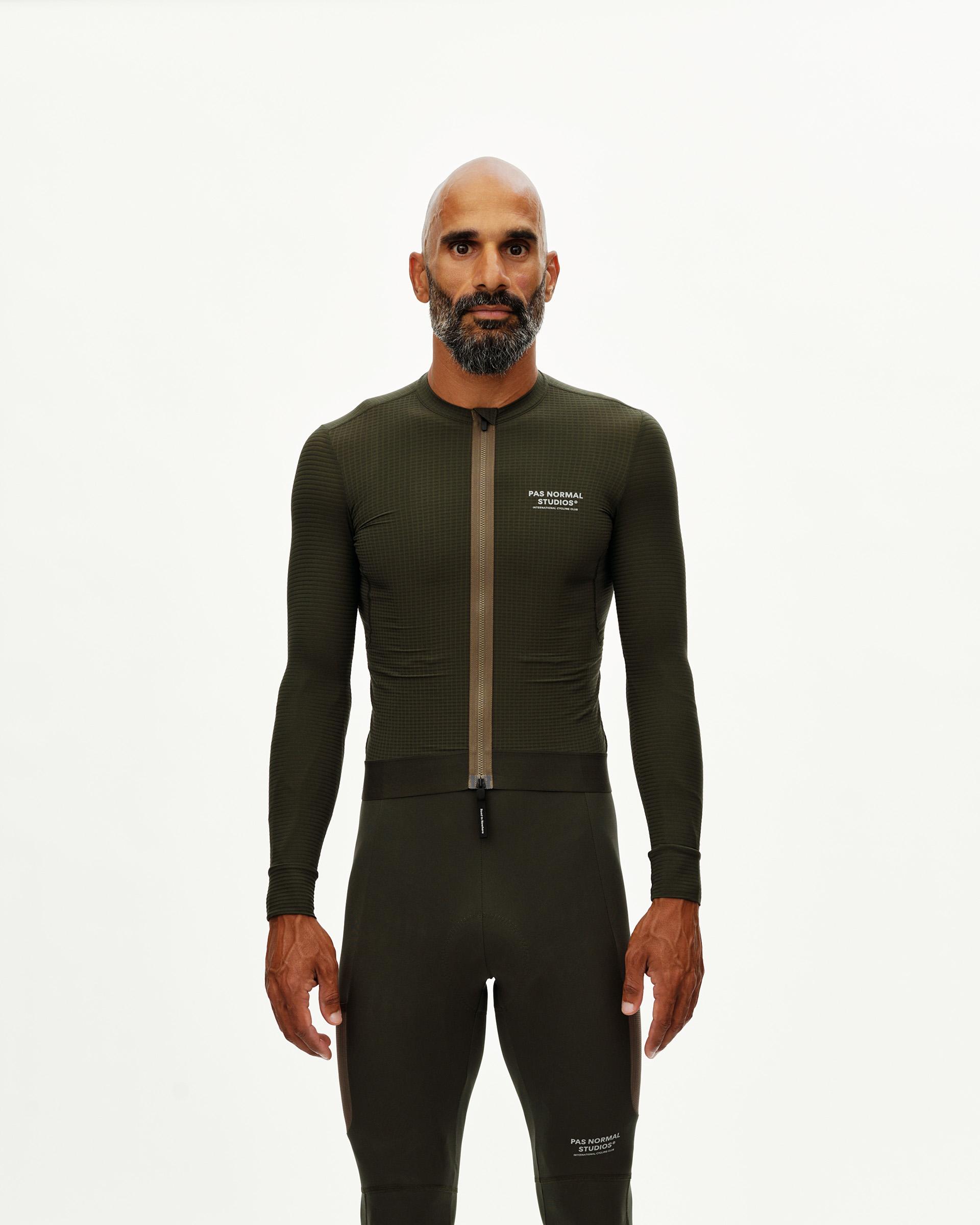 Dark Olive Escapism long sleeve cycling jersey on model, front view with full-length zip and textured fabric