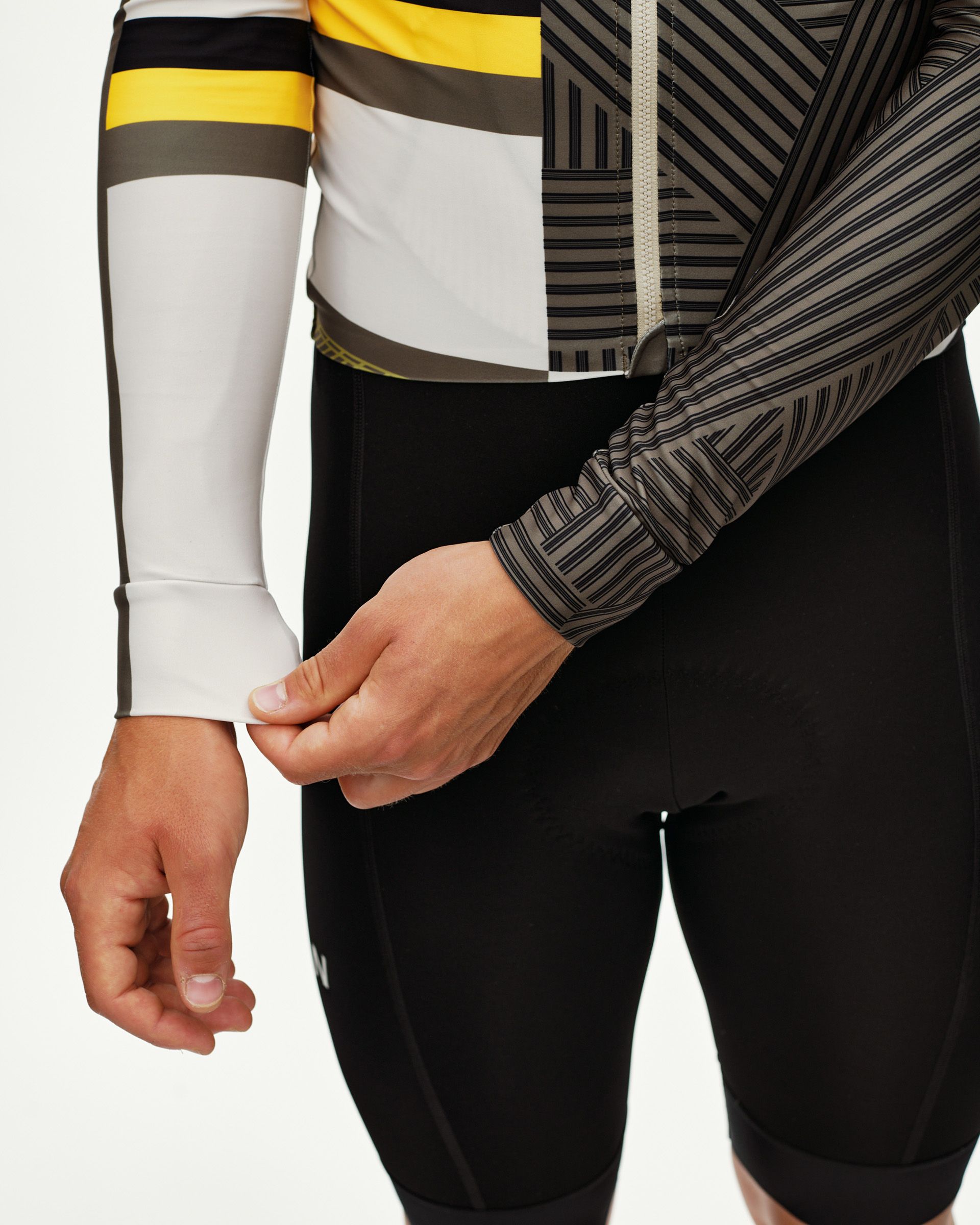 International Sand Mechanism long sleeve cycling jersey on model, detail view showing cuff and graphic stripe print