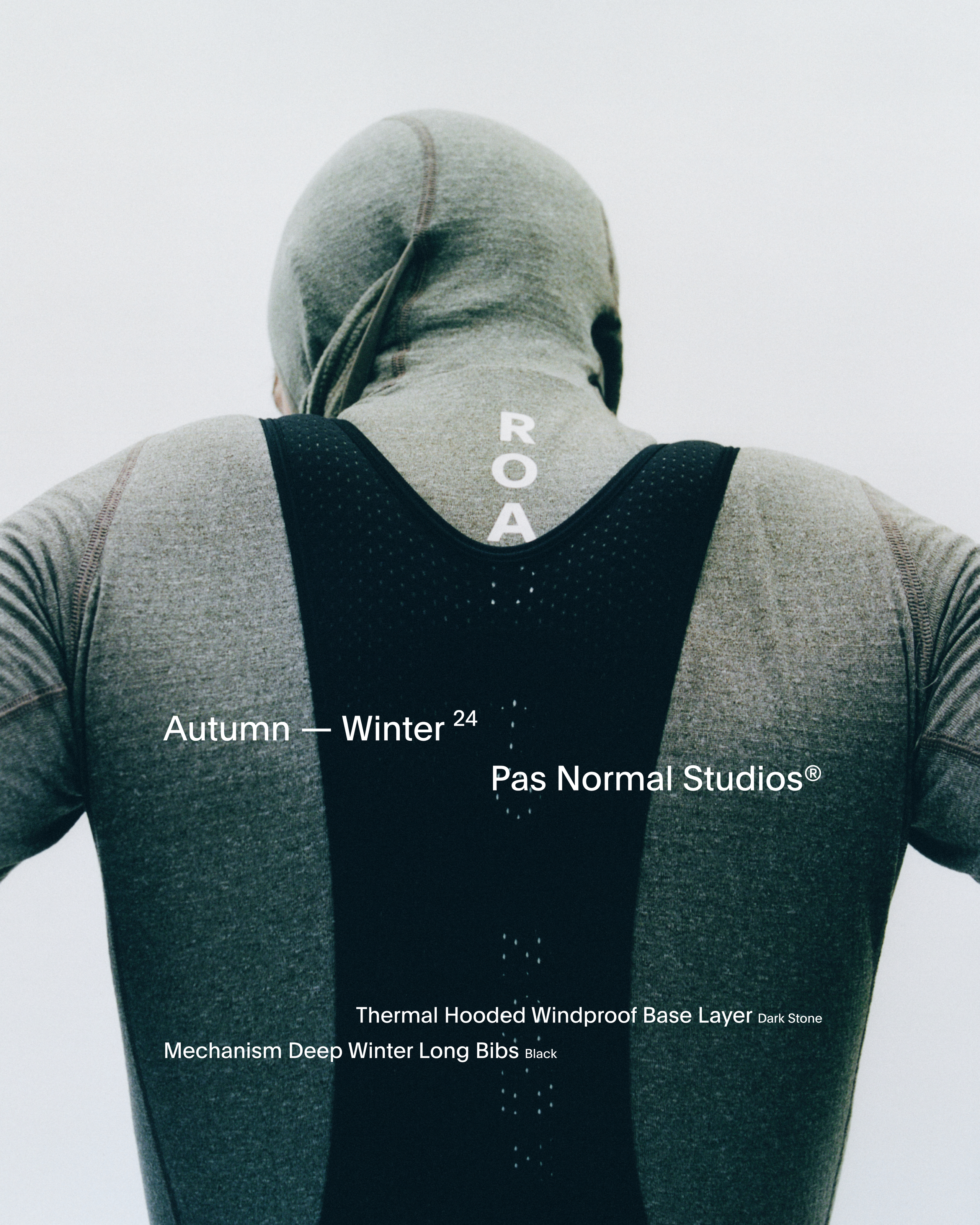 Model wearing dark grey hooded base layer and black Mechanism Deep Winter Long Bibs, rear view showing reflective detailing