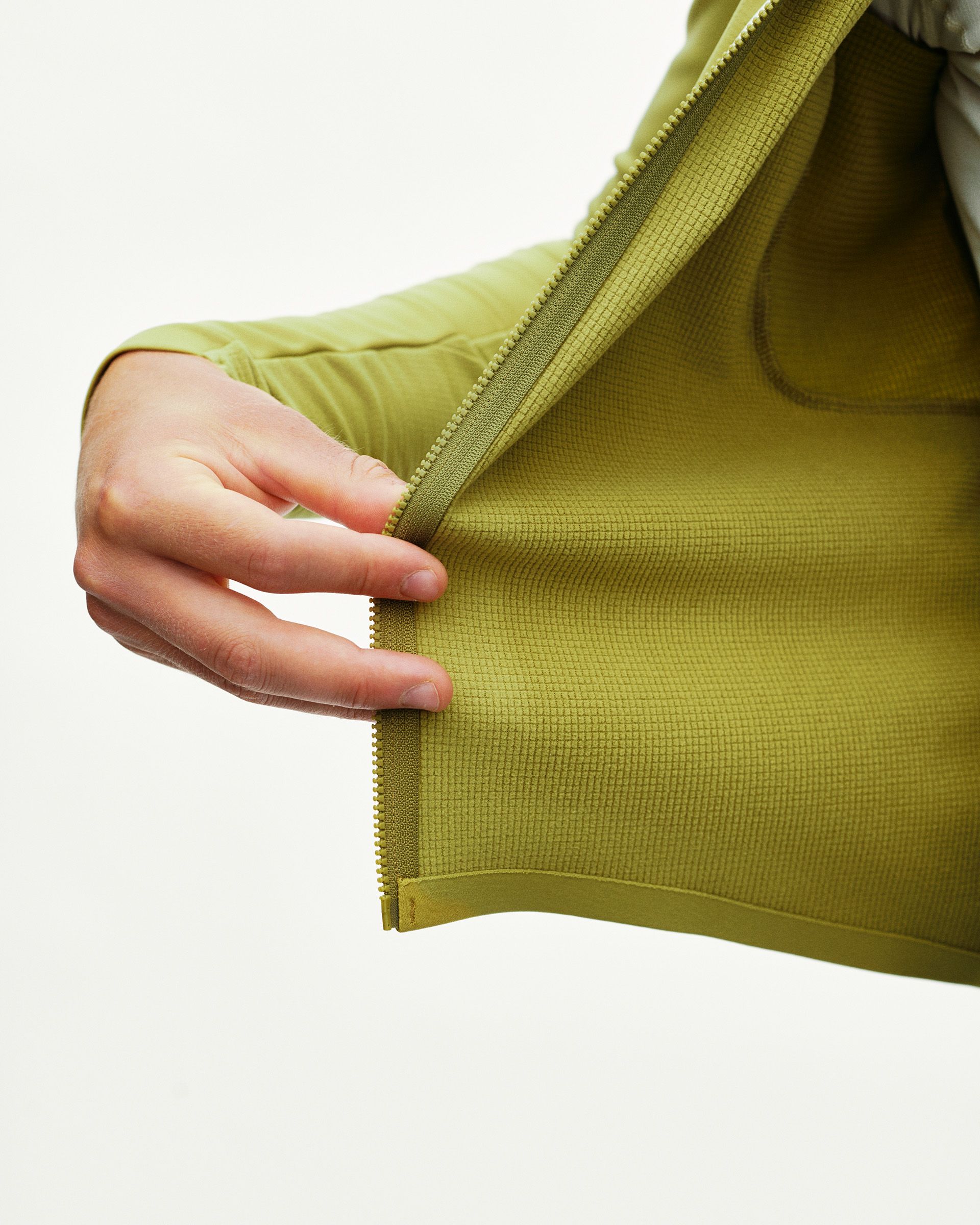 Dark Lime green PAS Mechanism Thermal Long Sleeve cycling jersey, detail view of zip placket and grid-fleece inner lining