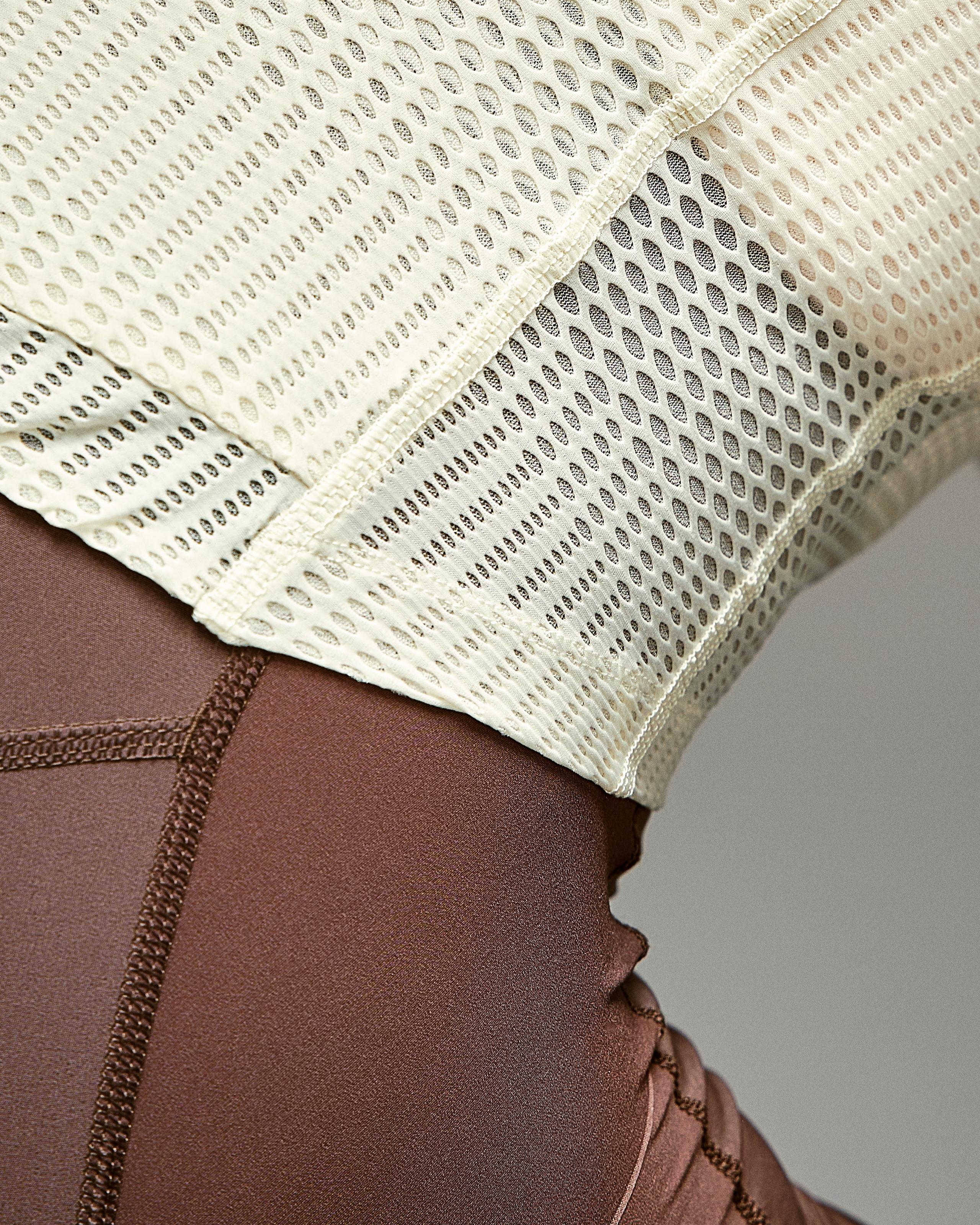 Off White Mechanism Pro Zipless cycling jersey detail showing perforated mesh panel construction