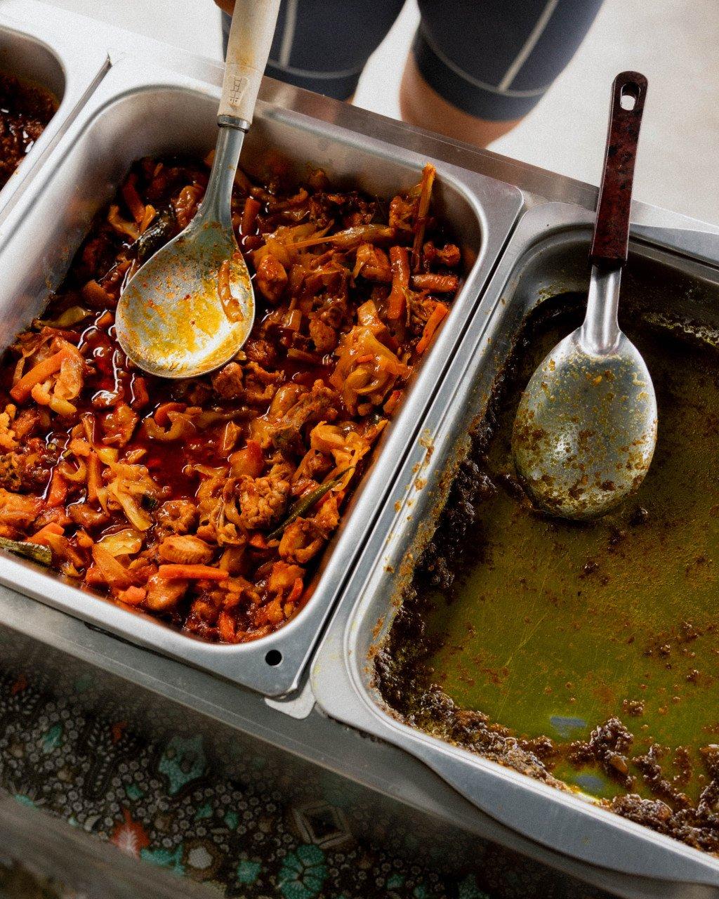 This image appears to be of food preparation rather than cycling apparel. It shows cooking pans with what looks like a spicy dish and sauce, which doesn't match the context of a premium cycling apparel website. Could you please verify this is the correct image for the Pas Normal Studios content?