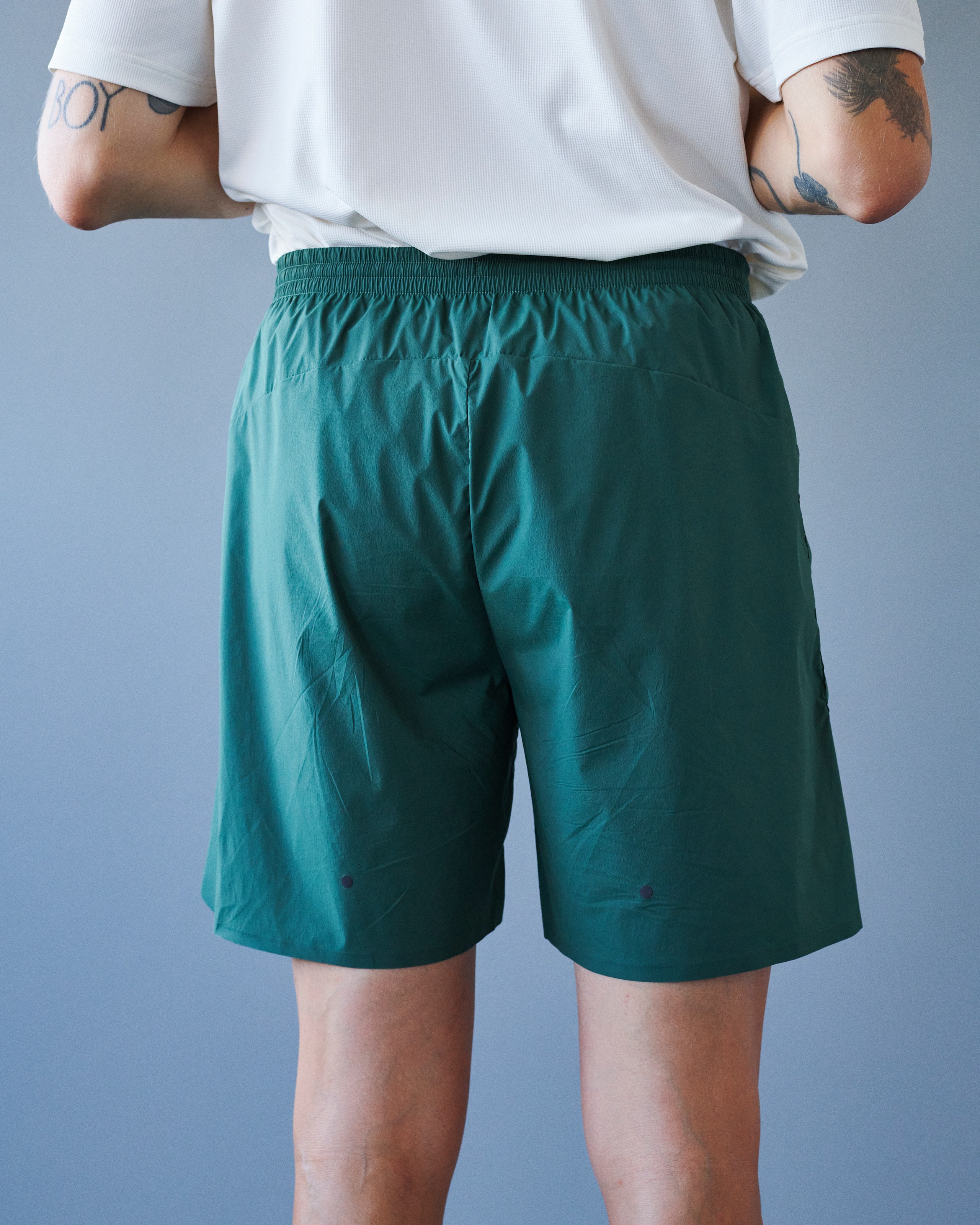 Green Balance shorts on model, rear view with elastic waistband