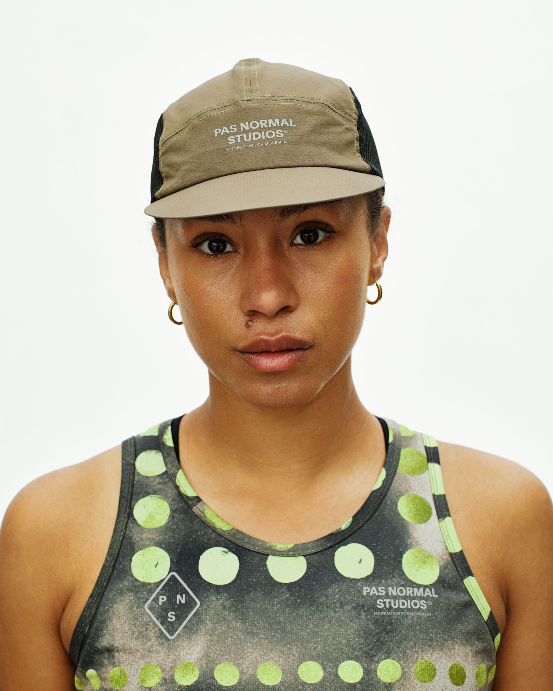 Dark Stone T.K.O. Balance cap on model with mesh side panels and white front logo