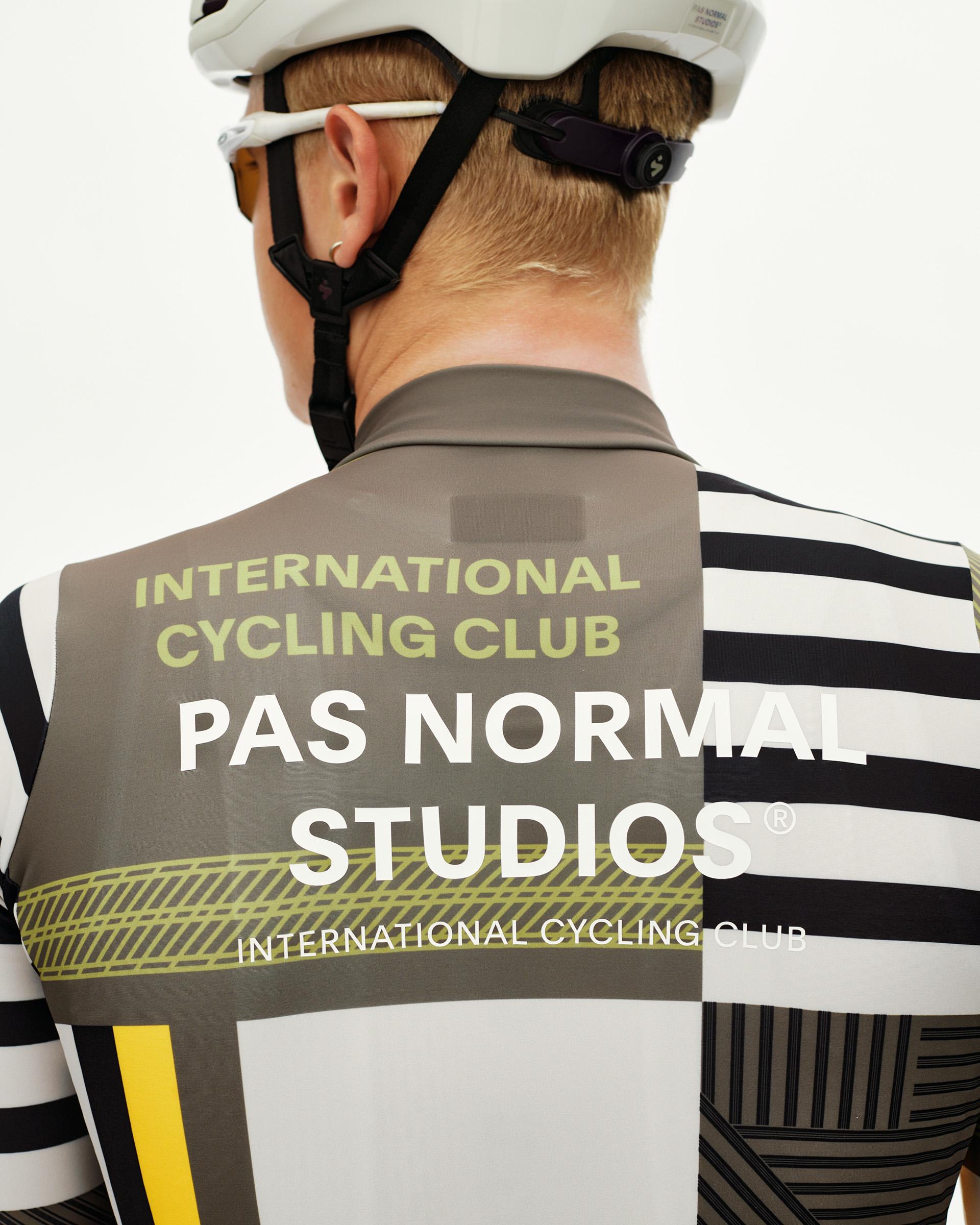 International Sand Mechanism long sleeve cycling jersey on model, rear view with graphic block print and stripe pattern