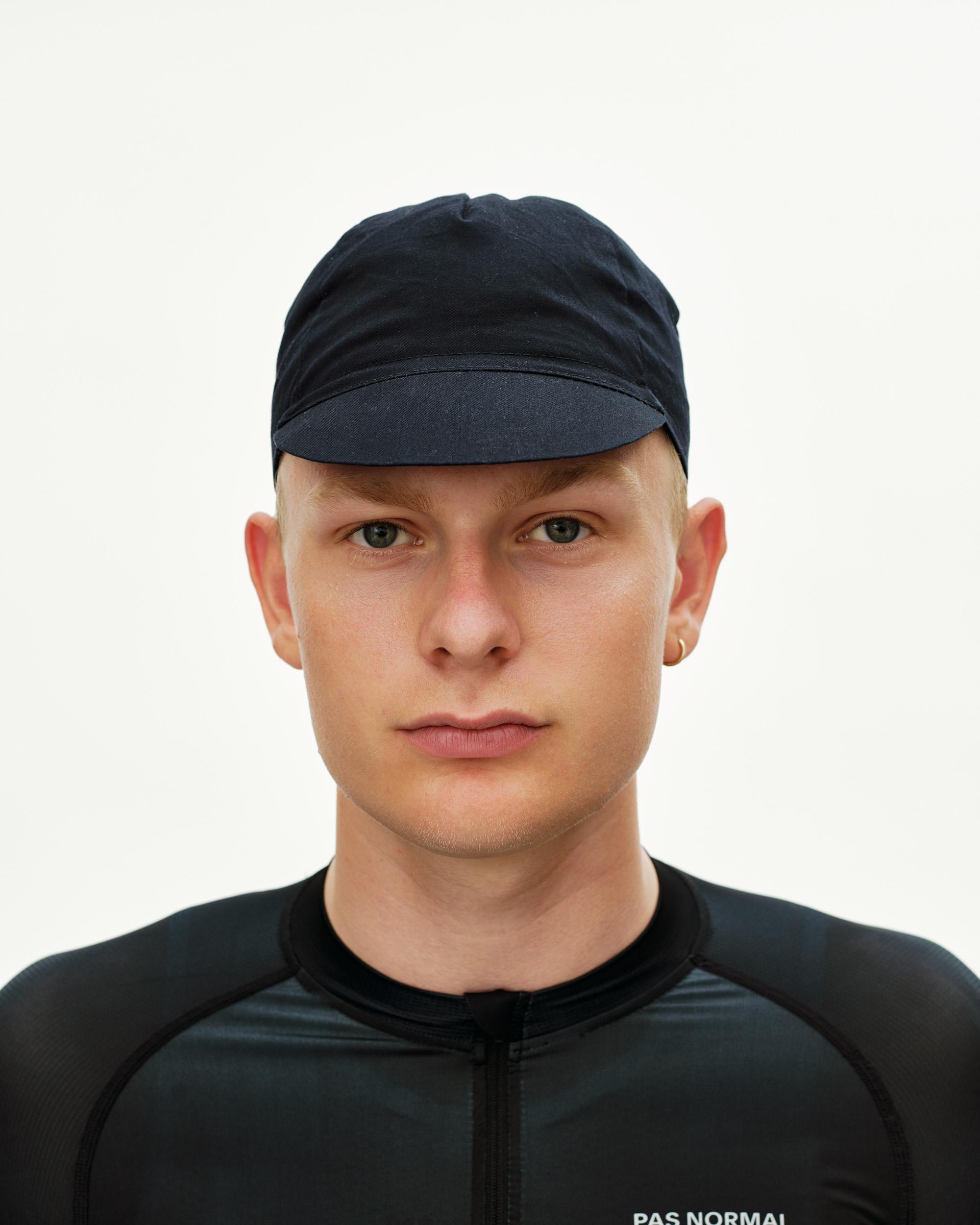 Black Logo Cap cycling cap on model, front view with short brim