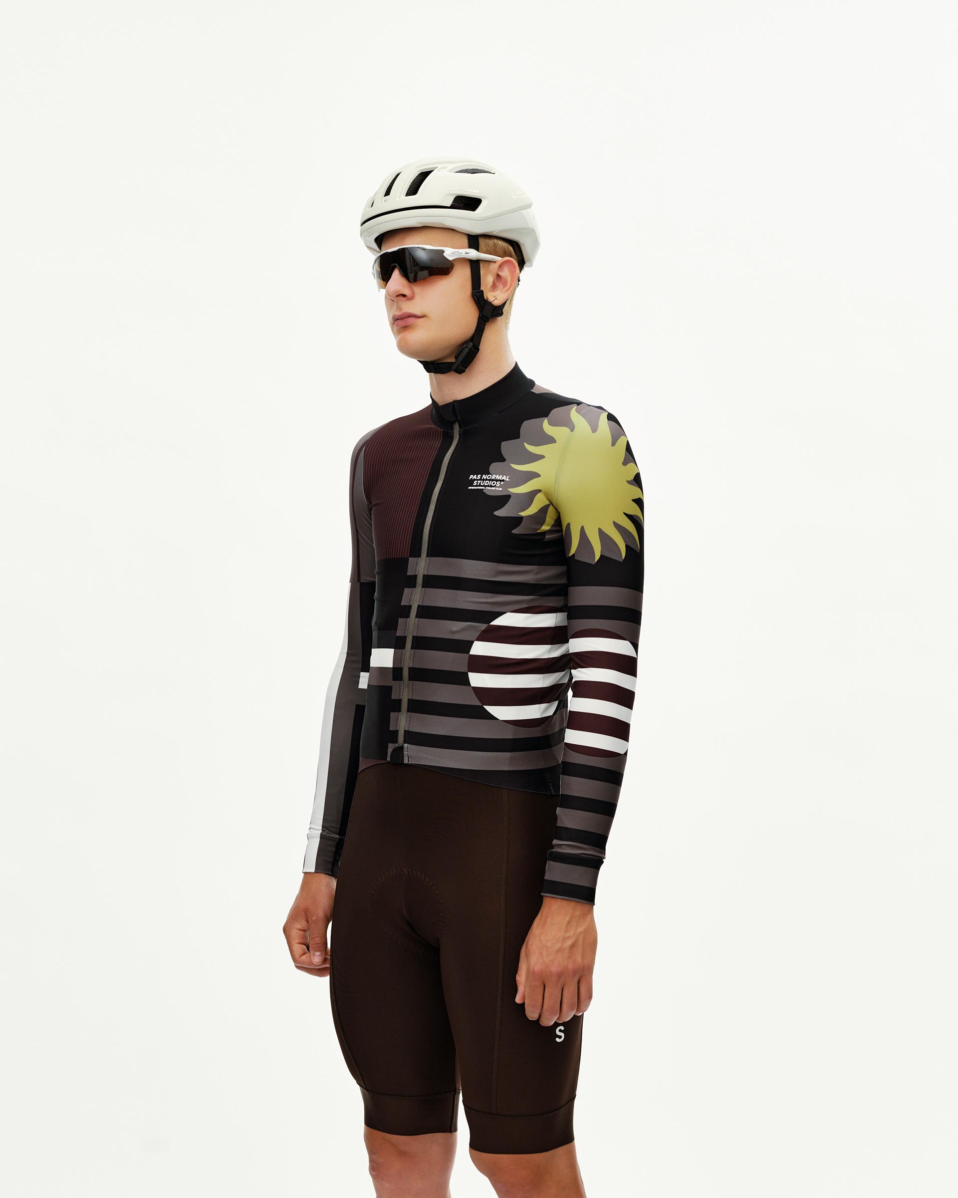 International Dark Olive Mechanism long sleeve cycling jersey on model, three-quarter front view with sun and stripe graphic