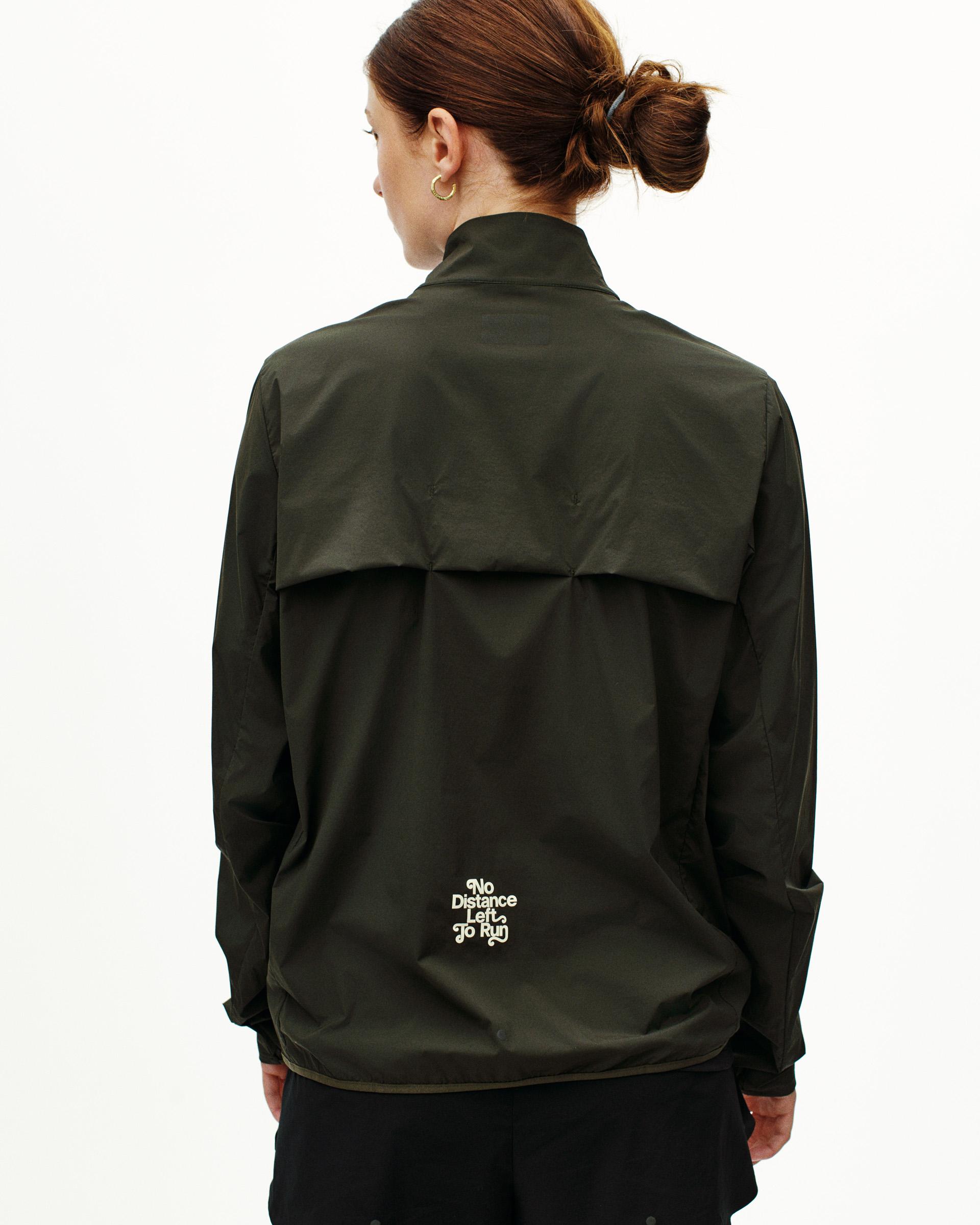 Dark Olive Balance Half Zip jacket, rear view on model with white logo print
