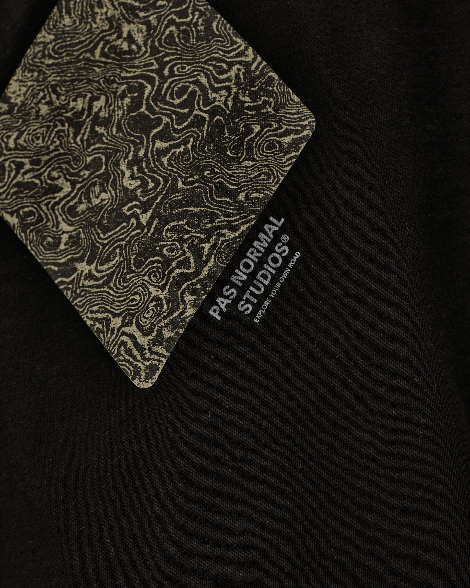 Black Off-Race Graphic T-Shirt, detail view showing topographic map print label card against black fabric