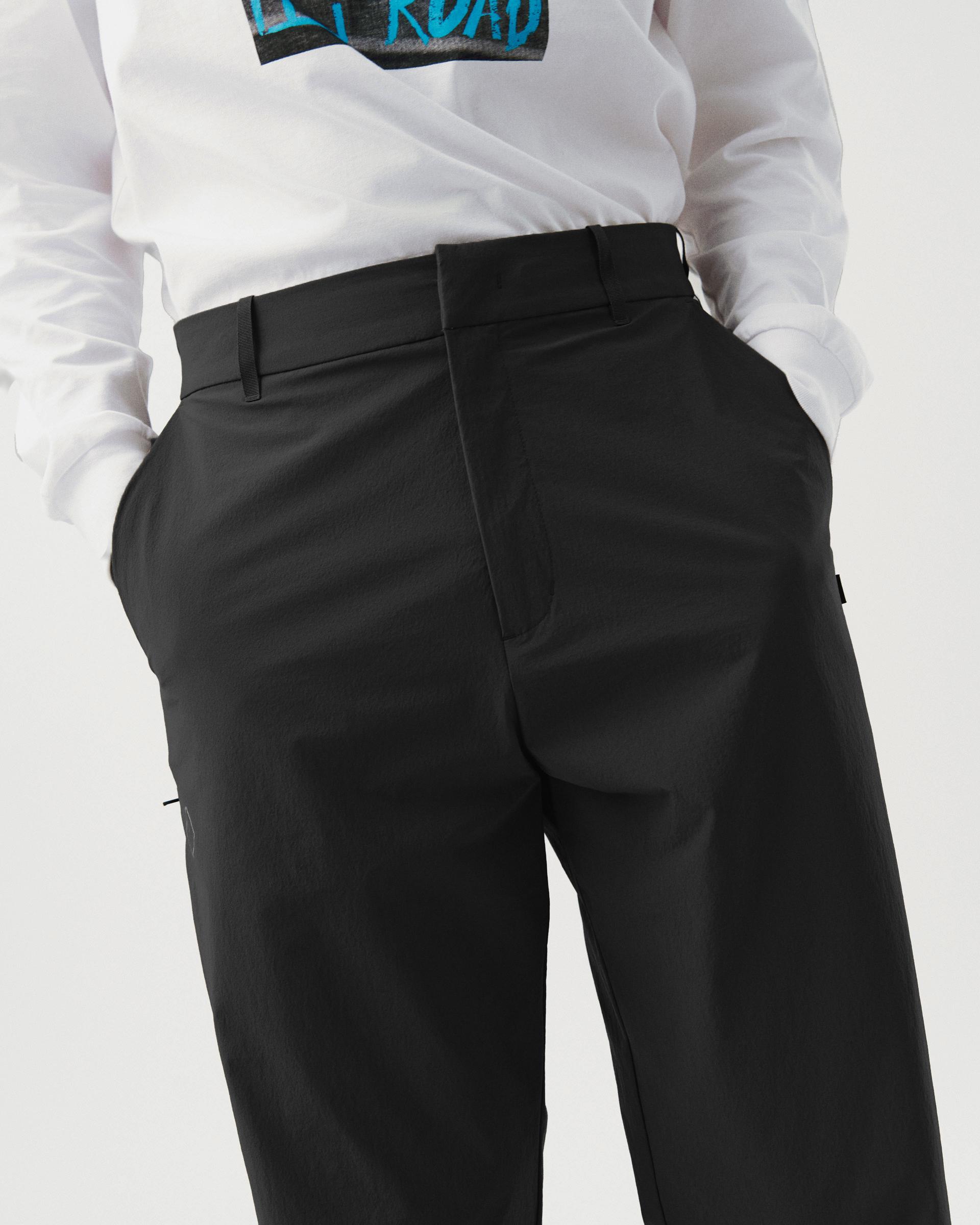 Black Off-Race Tech pants on model, front three-quarter view with tailored waistband and side seaming