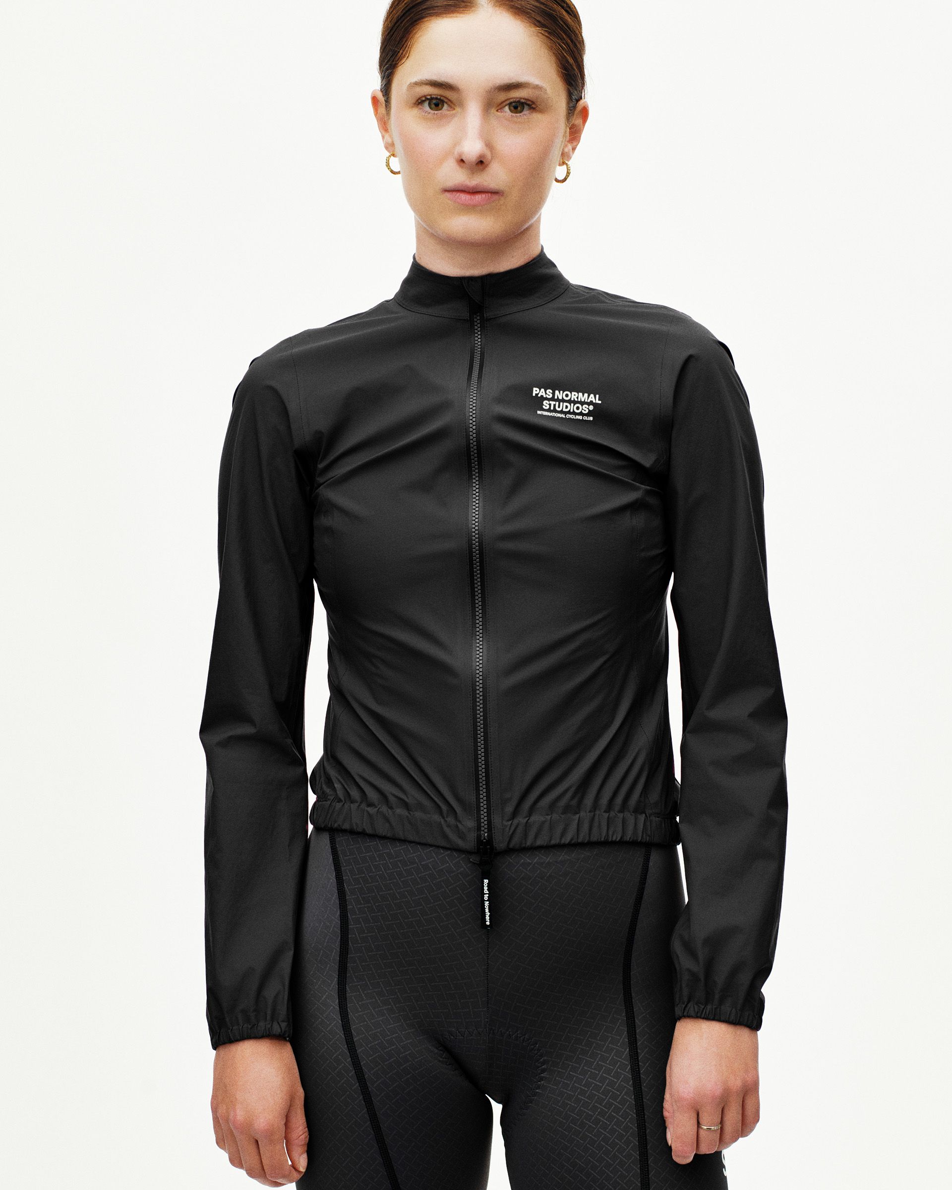 Black Mechanism Rain cycling jacket on model, front view with full zip and white chest logo