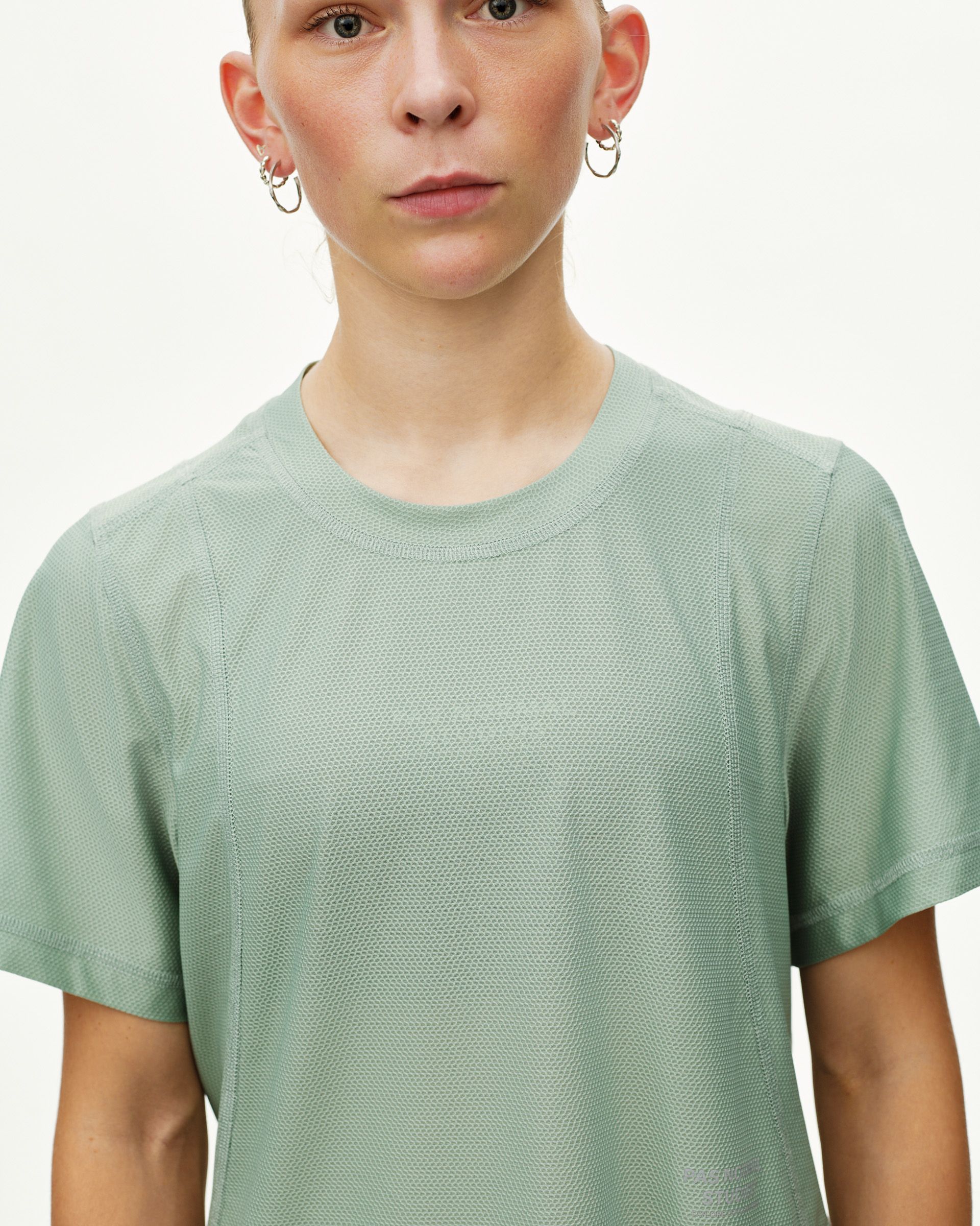 Green Sage Balance women's T-shirt, front view on model with textured mesh fabric and crew neck