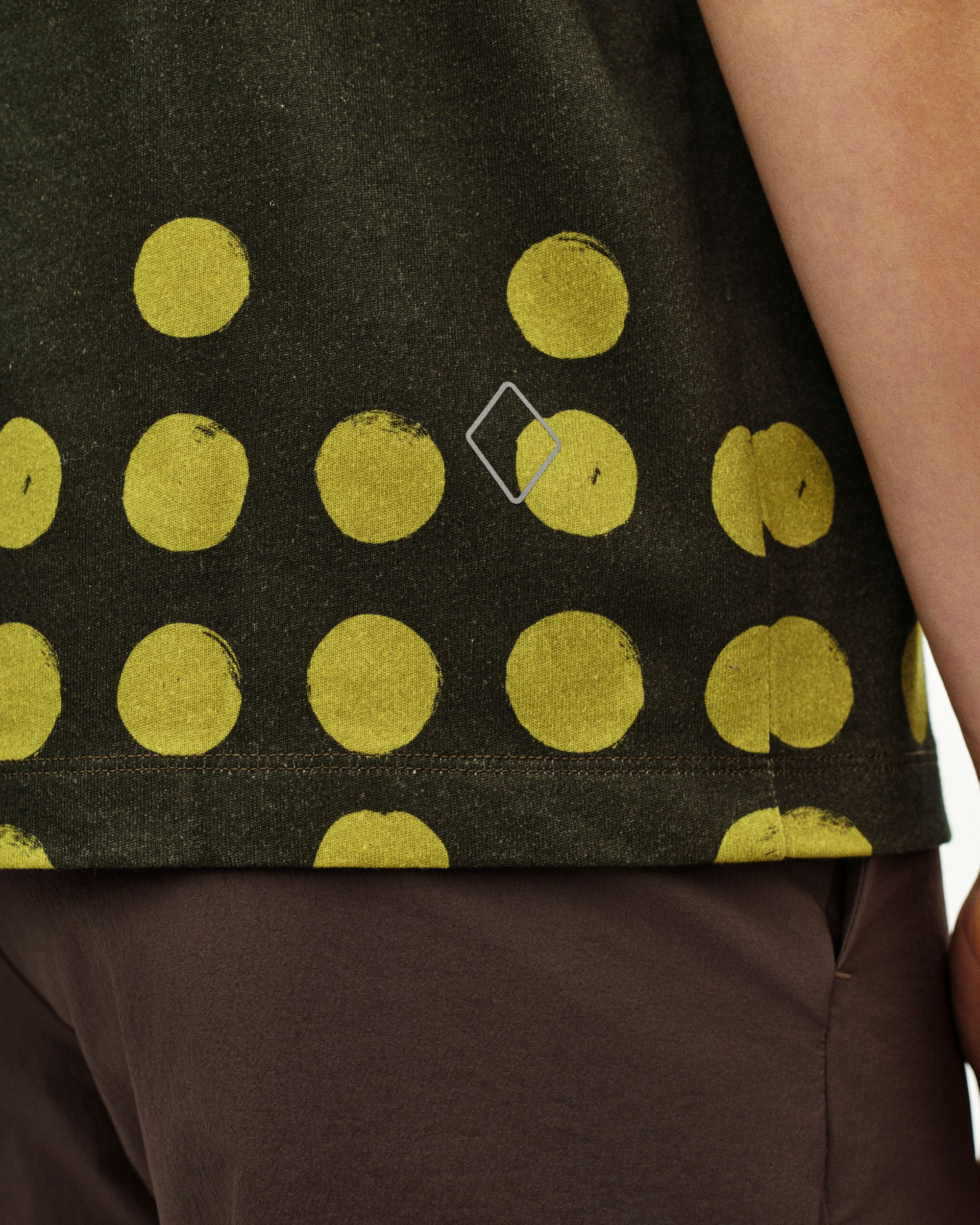 Brown Off-Race Graphic t-shirt on model with yellow polka dot print