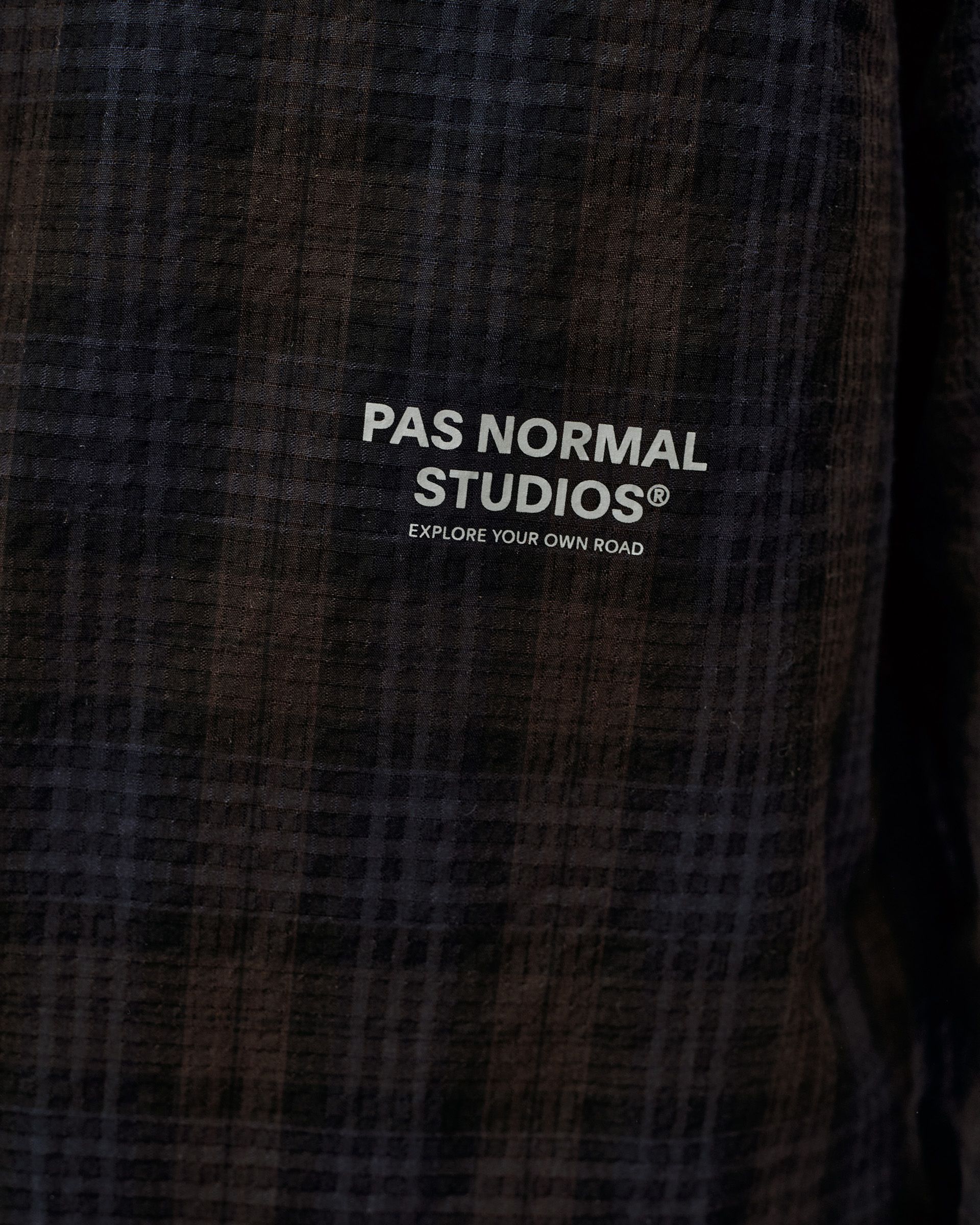 Dark Navy Off-Race Seersucker shirt, detail view of chest logo on dark plaid textured fabric