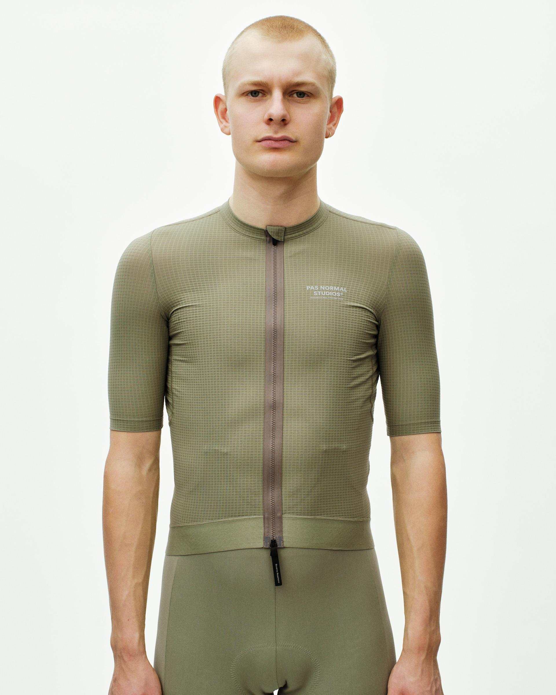 Light Olive Escapism cycling jersey on model with textured fabric and full front zip