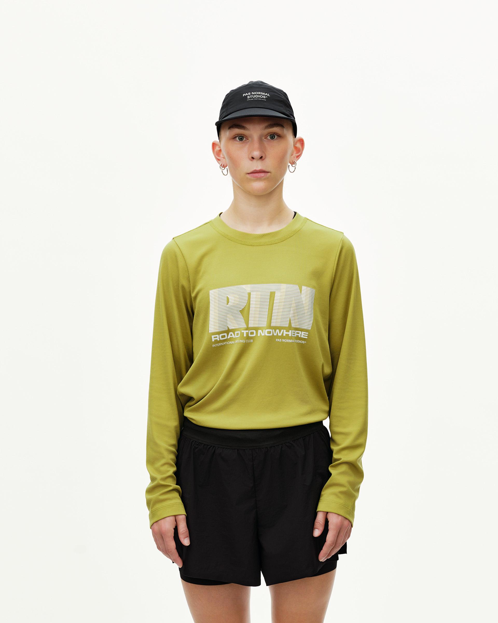 Black Balance 2-in-1 shorts on model, front view — paired with yellow-green long sleeve top with RTN chest print