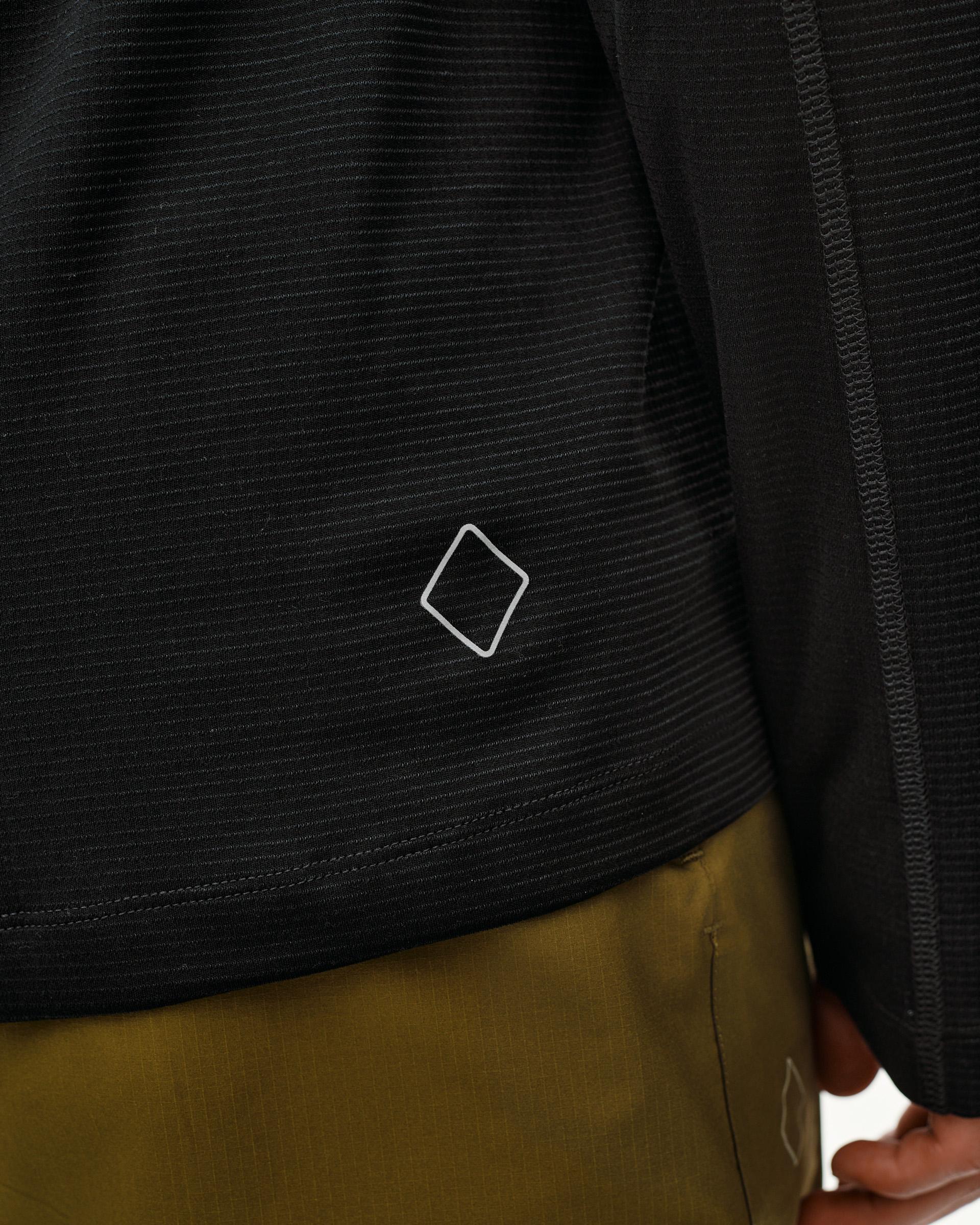 Black Balance long sleeve T-shirt, detail view on model showing diamond logo and ribbed texture