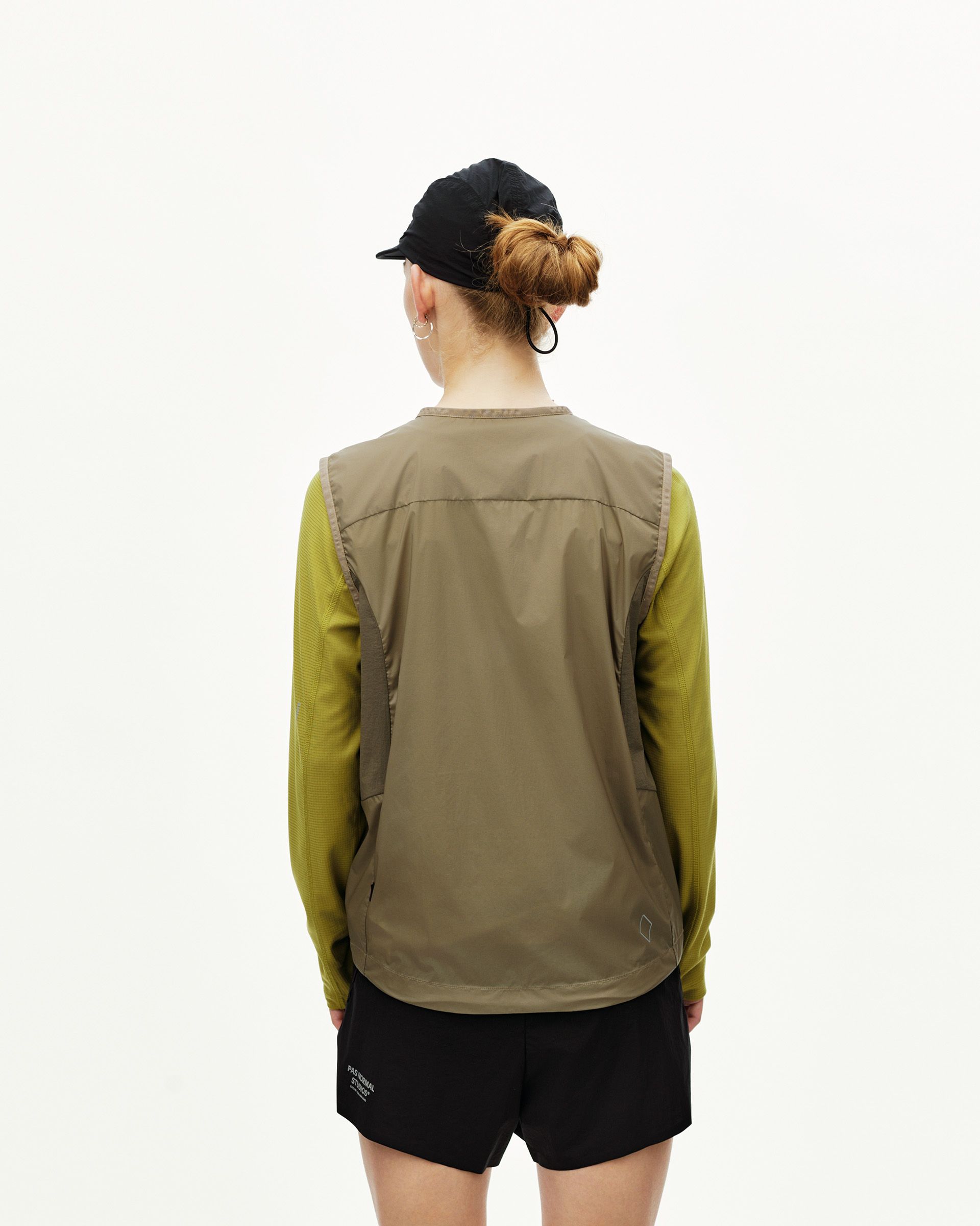 Dusty Earth khaki Balance Windproof vest on model, rear view with contrast panel seams