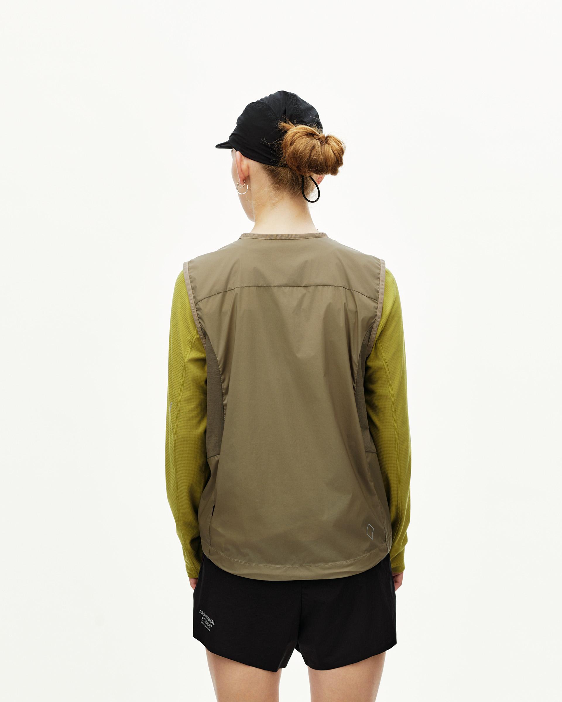 Dusty Earth khaki Balance Windproof vest on model, rear view with contrast panel seams