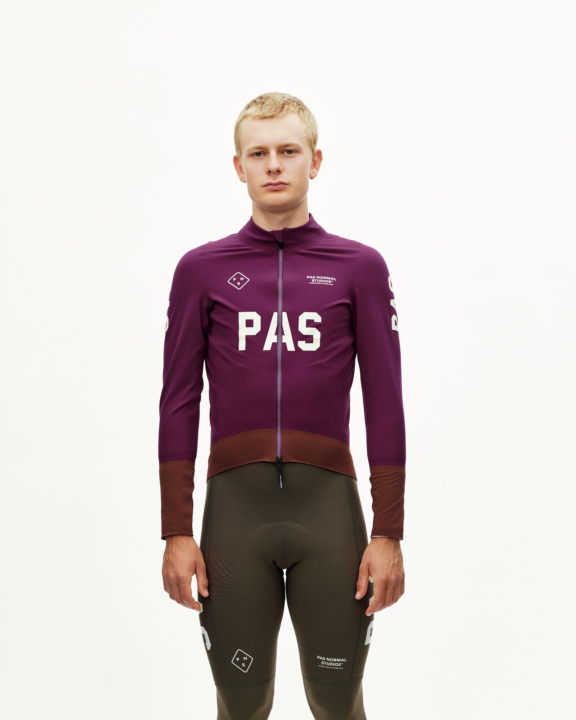 Dark Purple PAS Mechanism thermal cycling jacket on model, front view with large white chest logo and contrast dark hem panel