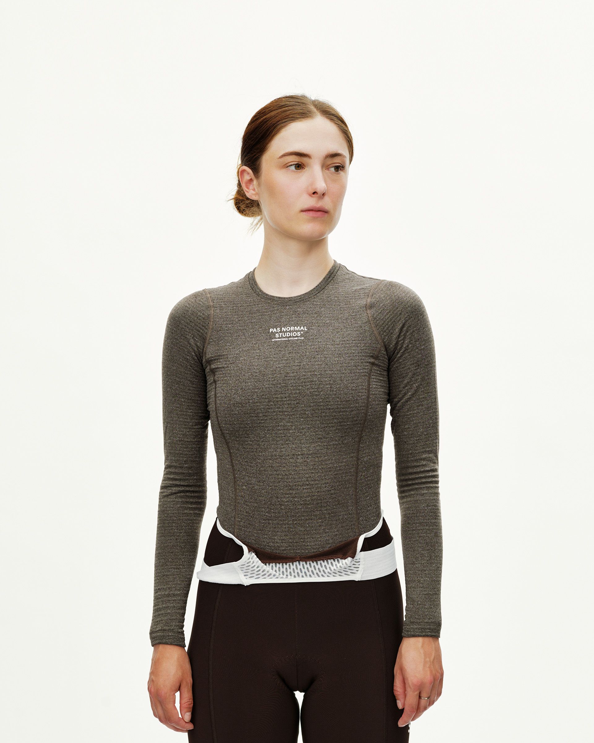 Dark Coffee brown Essential women's long sleeve cycling baselayer on model, front view with white chest logo print
