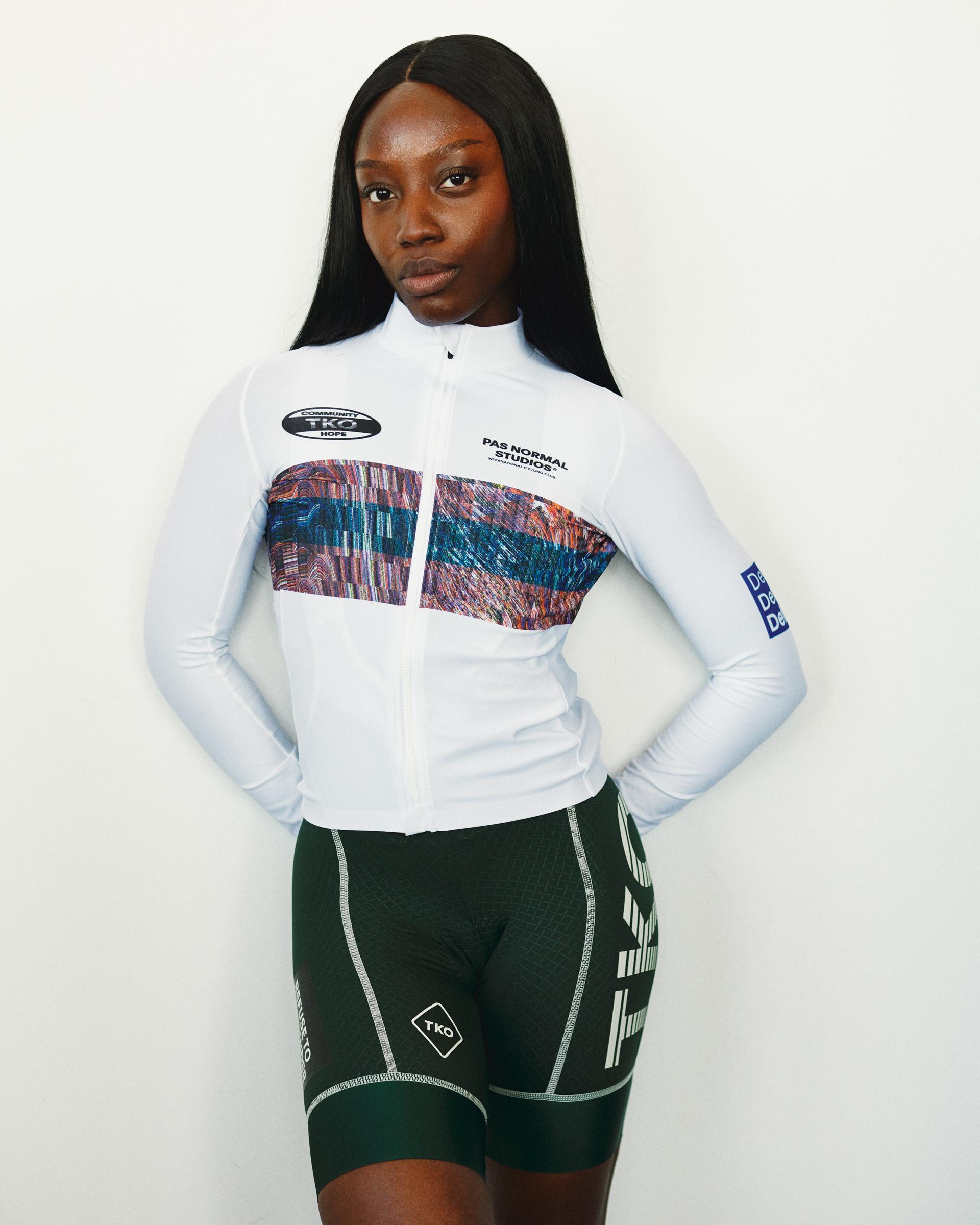 White T.K.O. Mechanism long sleeve cycling jersey on model, front view with multicolour chest panel print