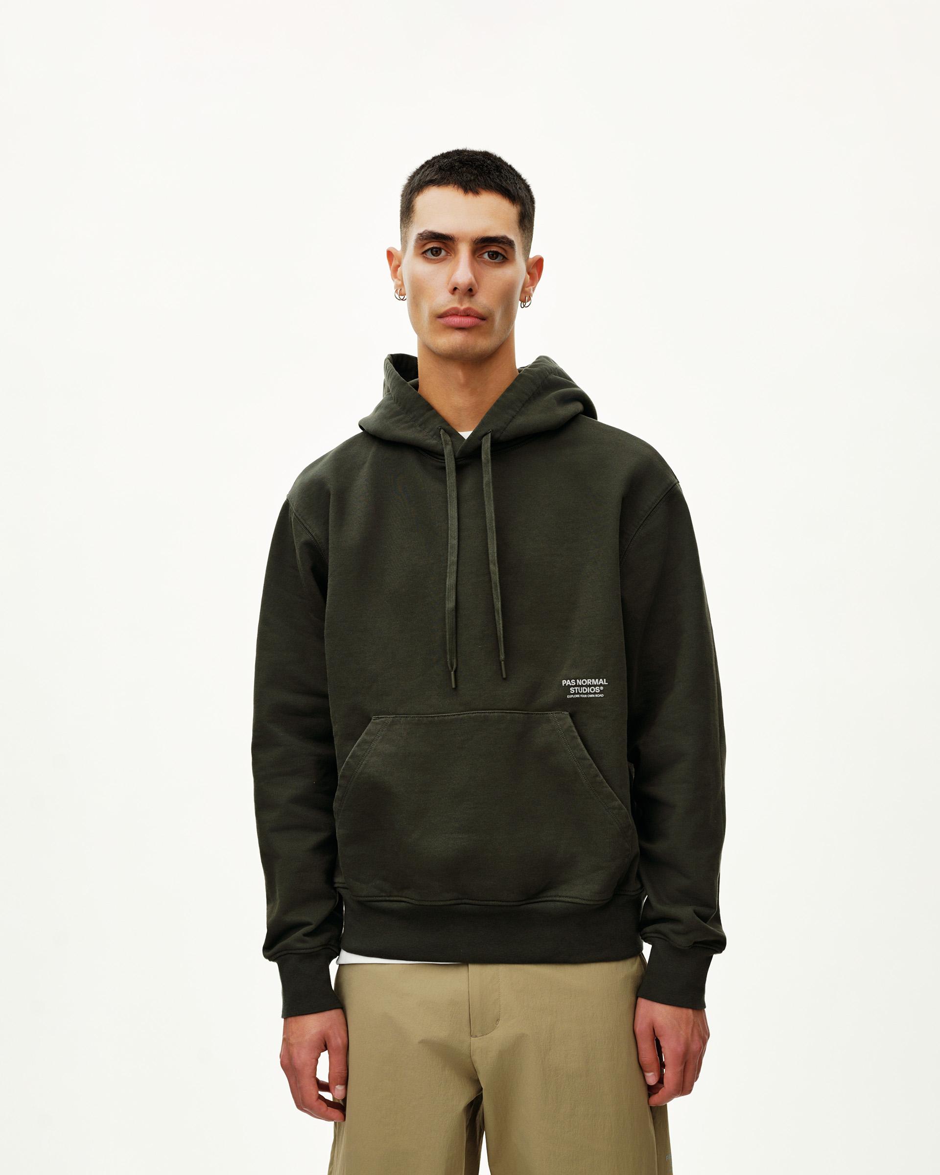 Dark Olive Off-Race hoodie on model, front view with kangaroo pocket and small chest logo print
