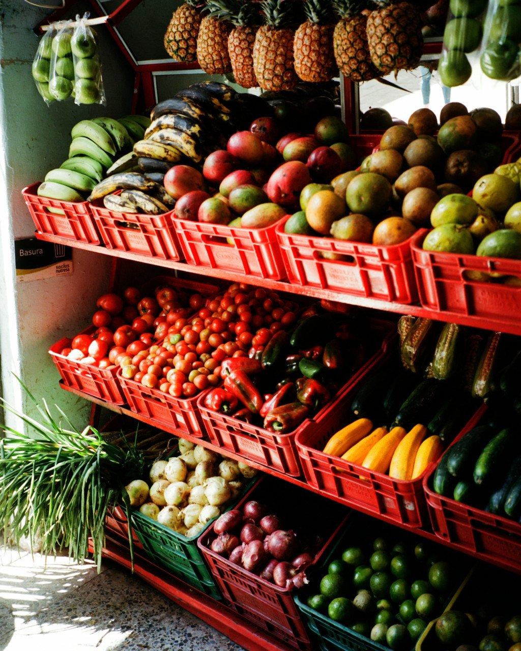 Fresh tropical fruits and vegetables displayed at Colombian market stall