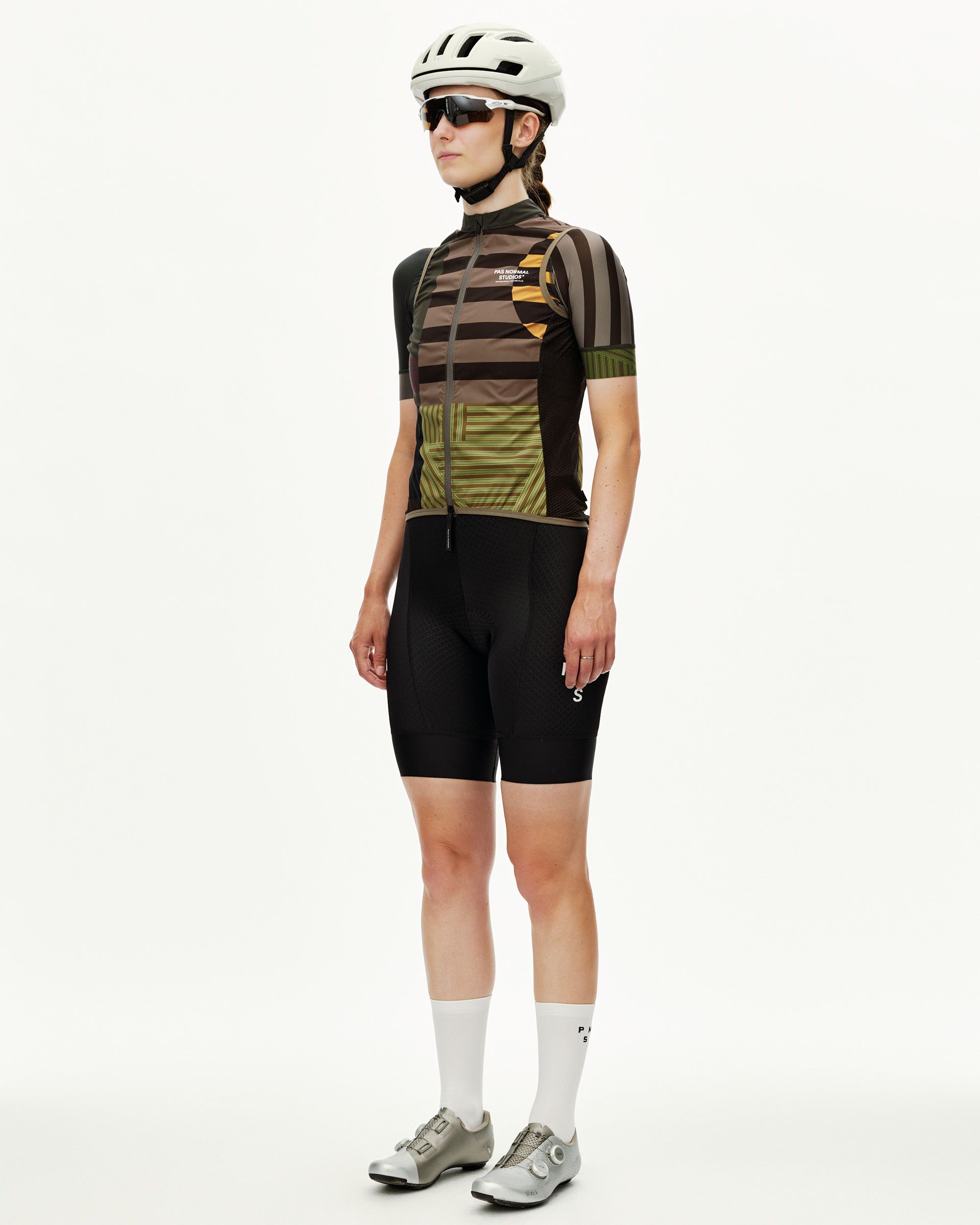 International Earth Mechanism Stow Away cycling gilet on model, three-quarter view with multicolor stripe print