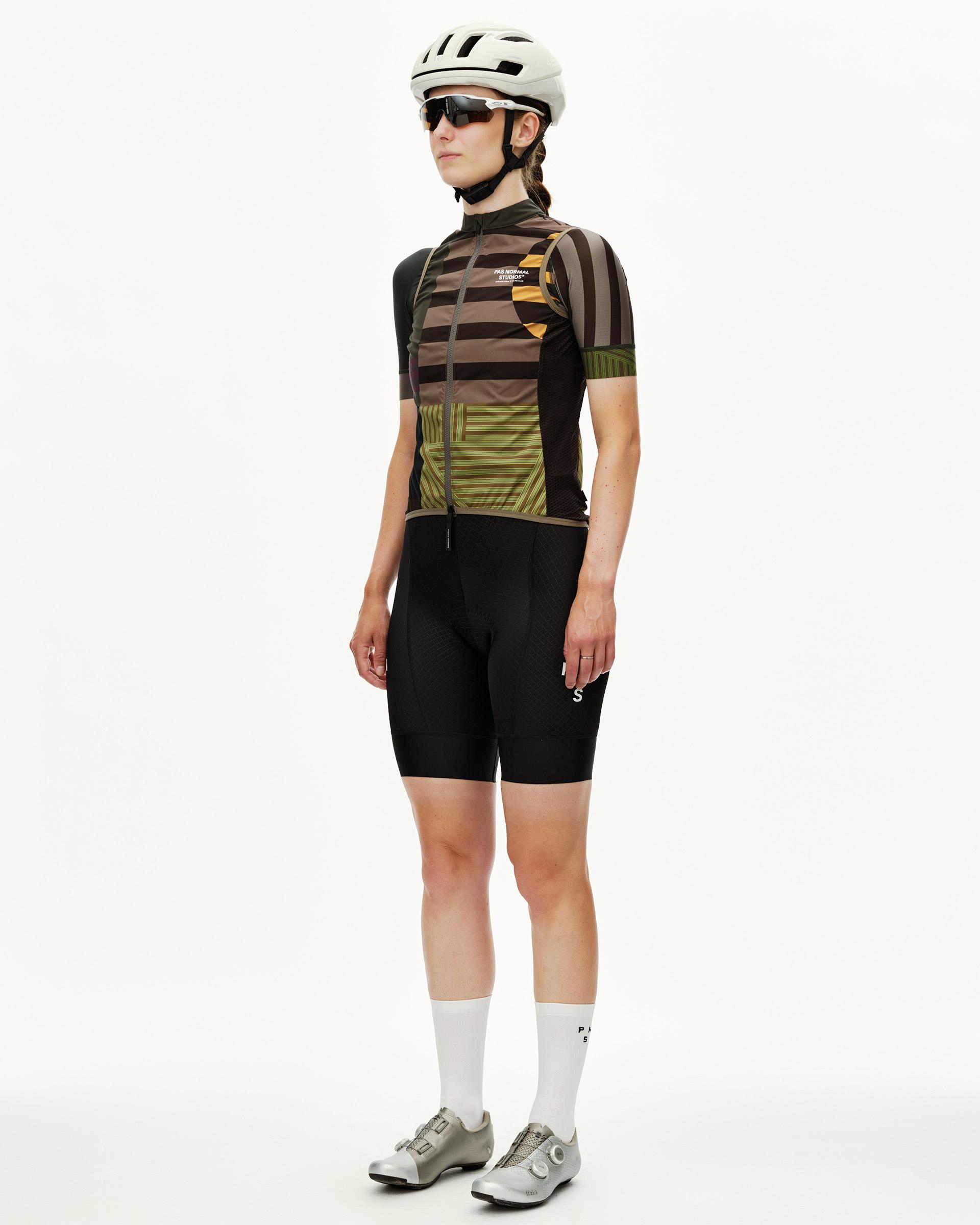 International Earth Mechanism Stow Away cycling gilet on model, three-quarter view with multicolor stripe print