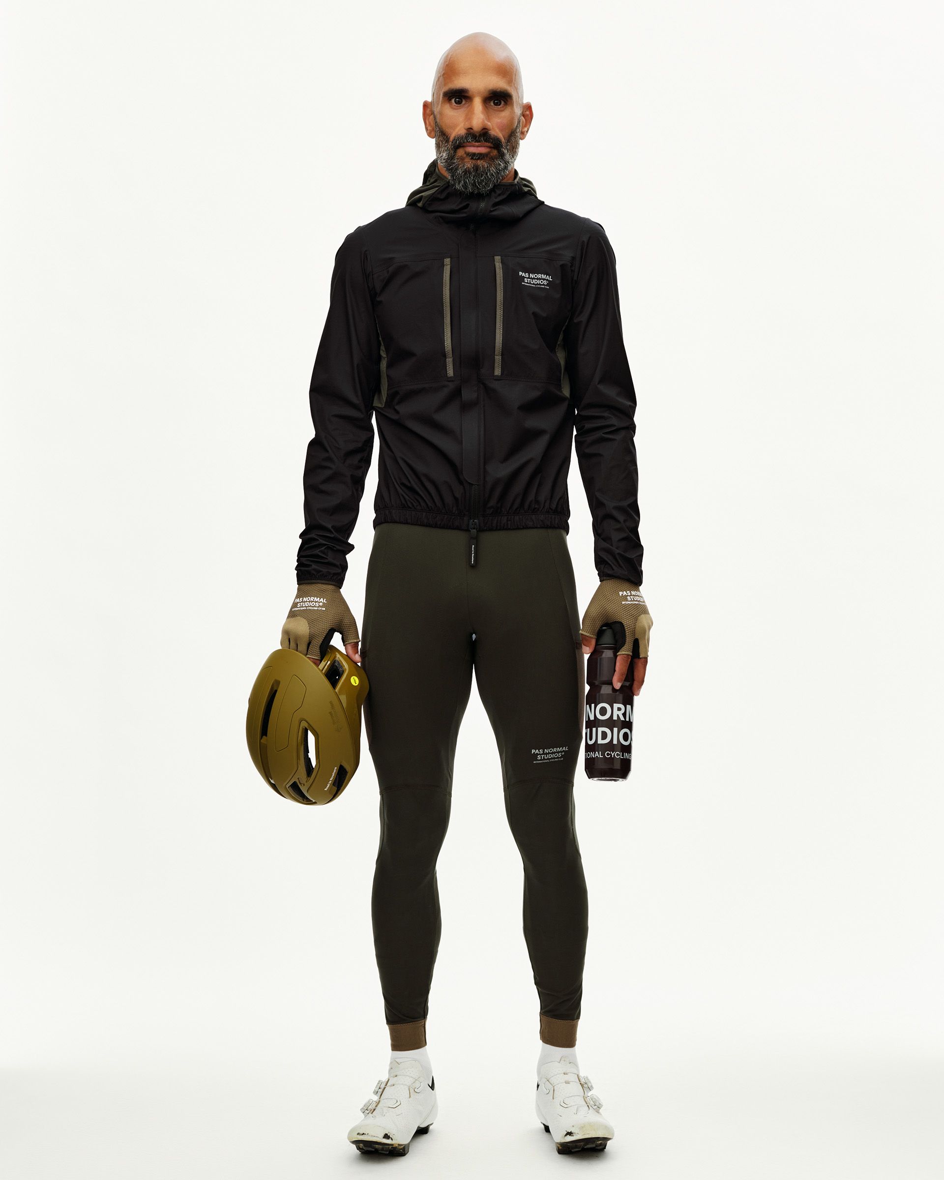 Black Escapism Hooded Lightweight cycling jacket on model, front view with chest logo print and elasticated hem
