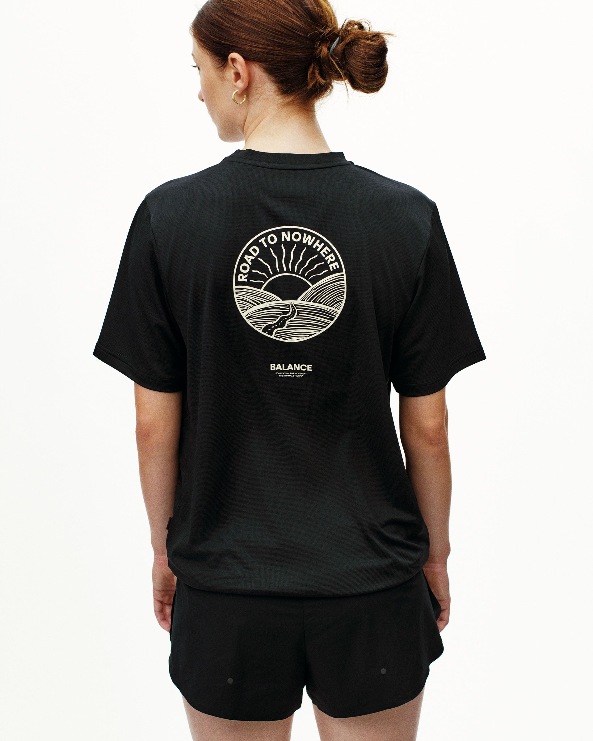 Black Balance t-shirt, rear view on model with white Road to Nowhere circular print