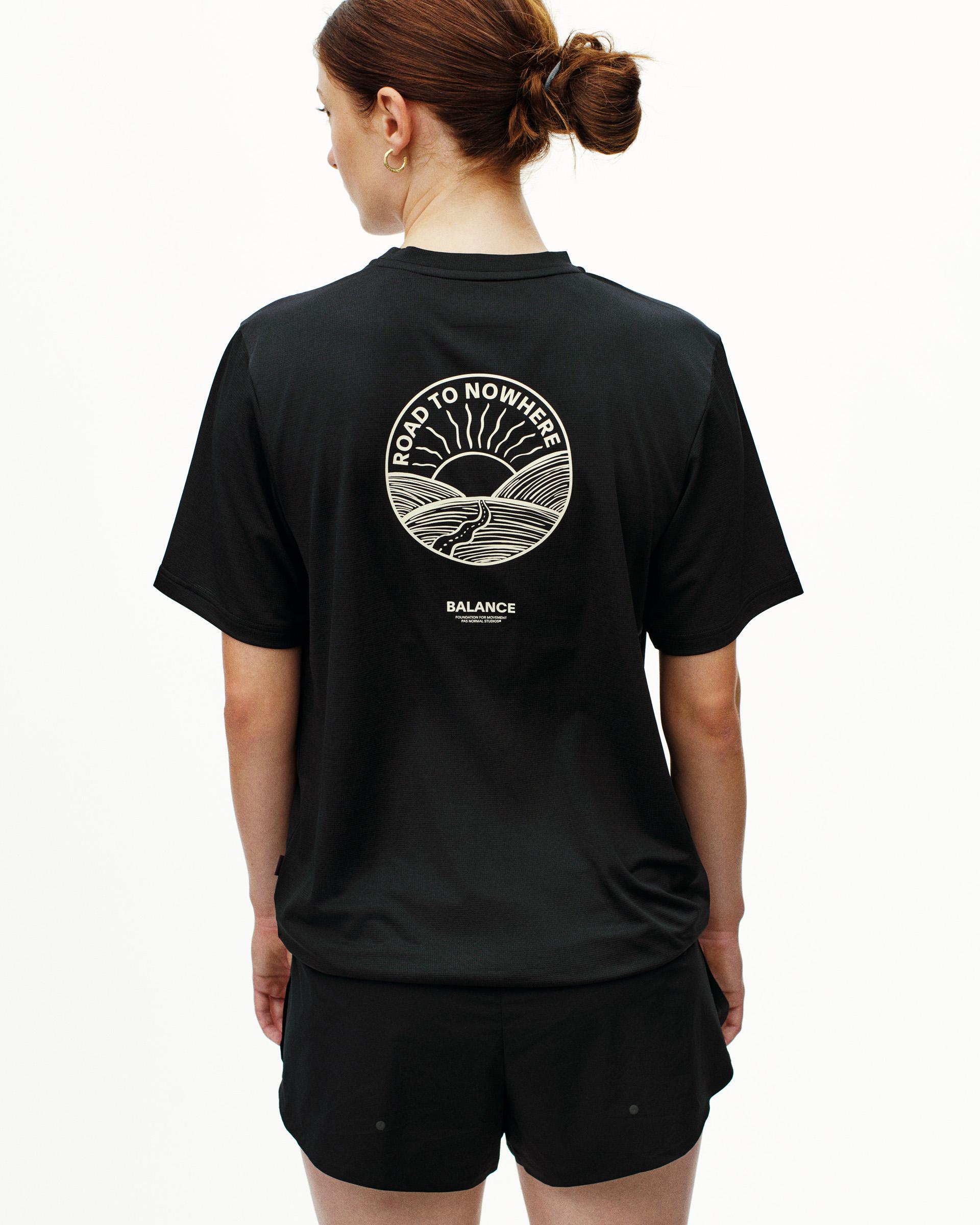 Black Balance t-shirt, rear view on model with white Road to Nowhere circular print