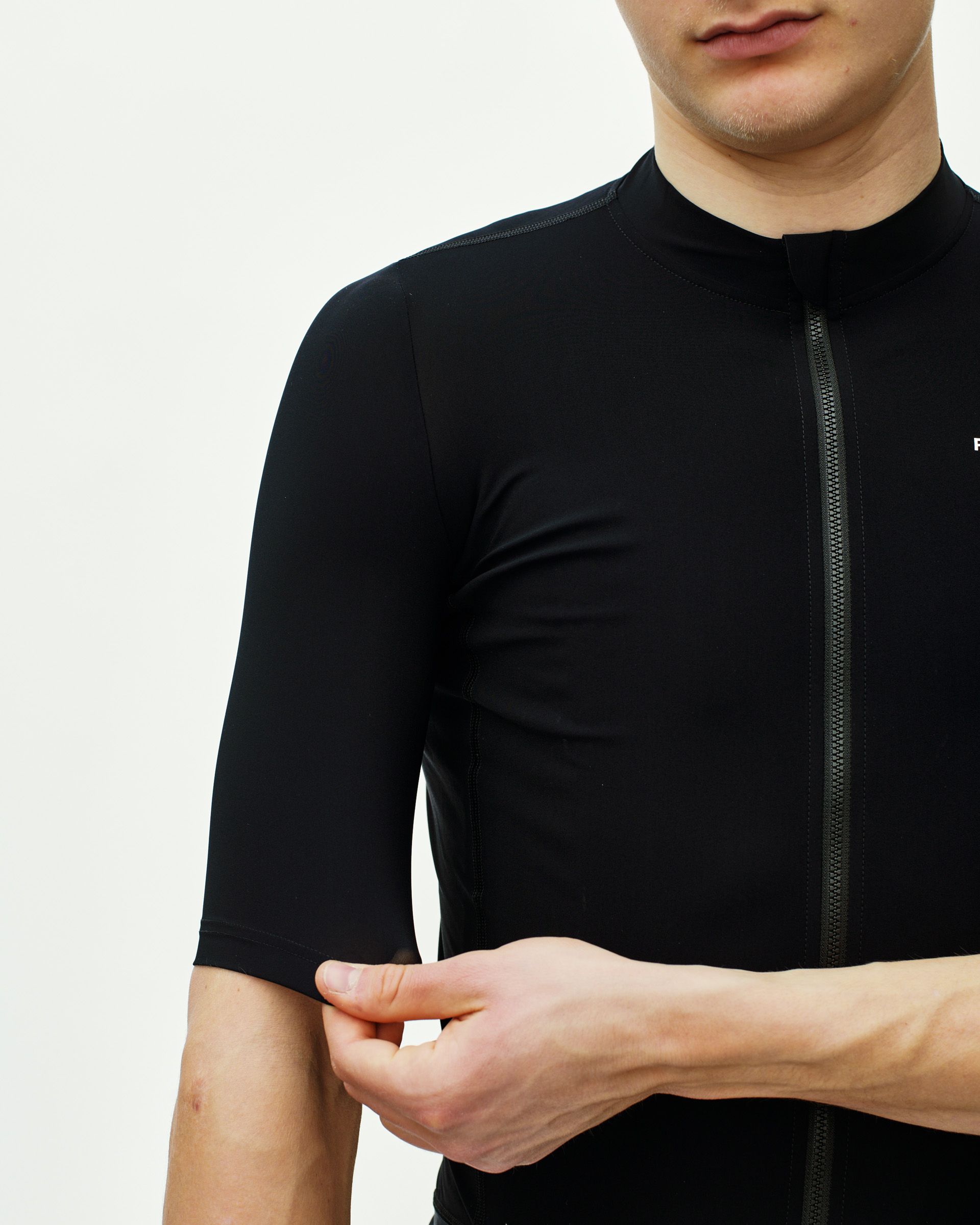 Black Essential cycling jersey on model with full front zip